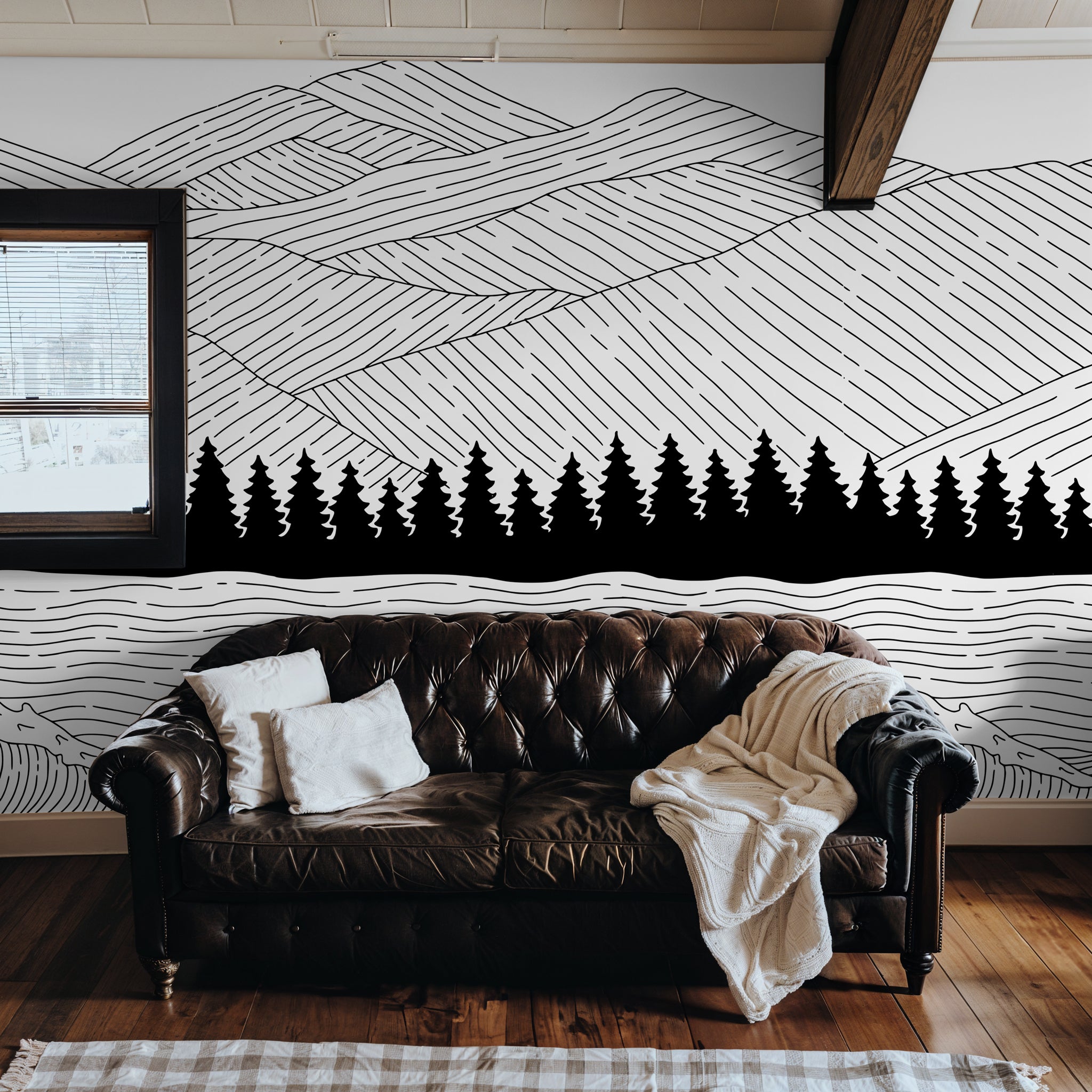 "Wall Blush's Sea to Summit Wallpaper featured in a cozy living room, highlighting the artistic mountain design."
