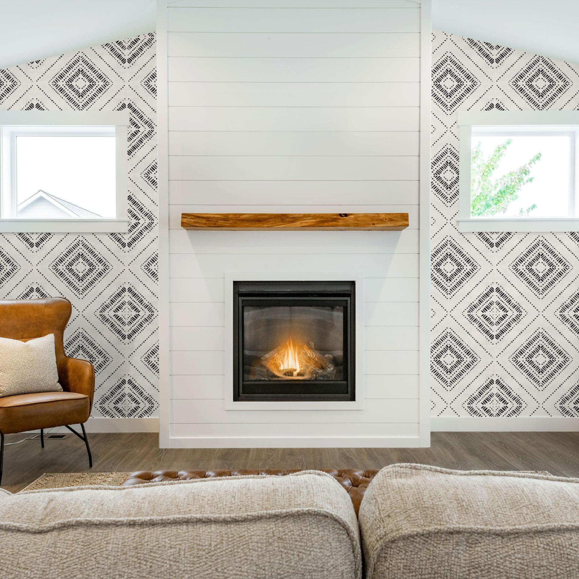 Anomaly Wallpaper by The Clements Crew Line featured in cozy living room with fireplace focal point.