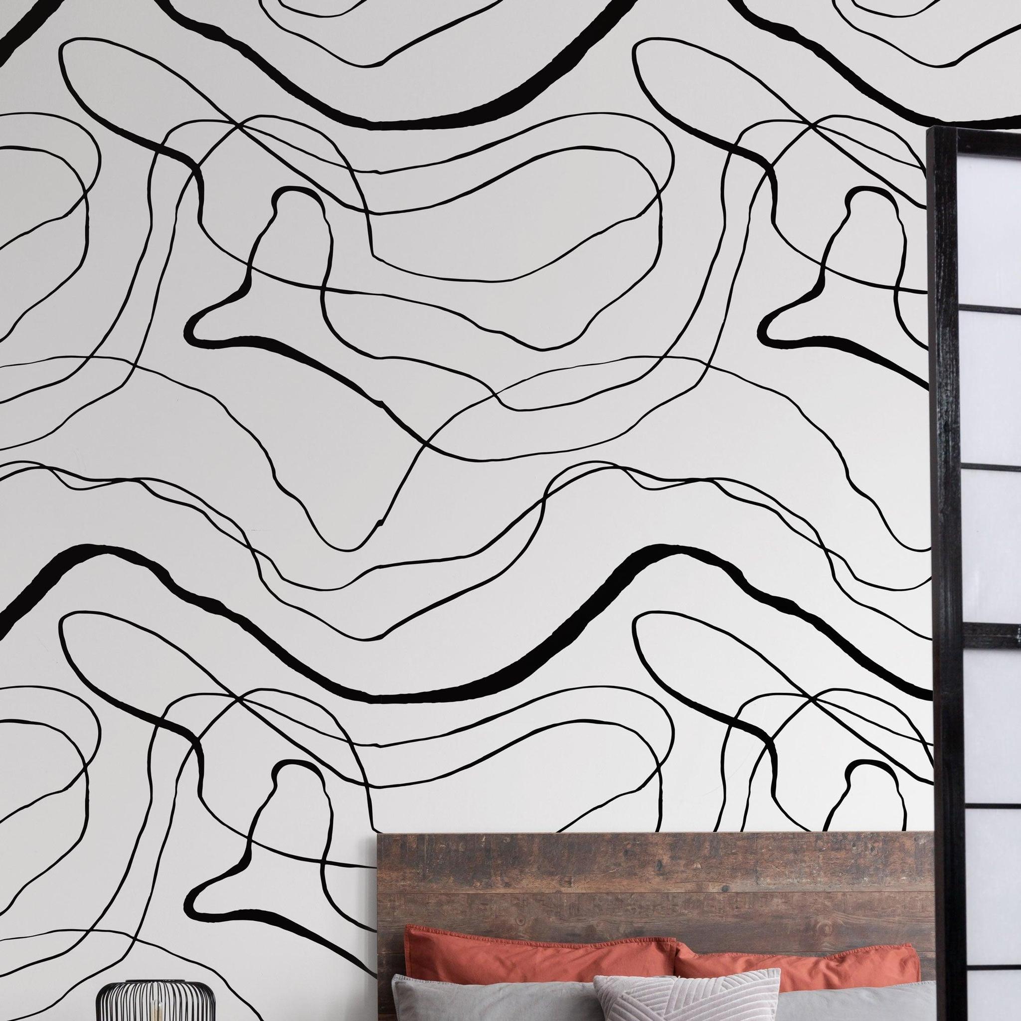 Belmore Wall Blush AW01 wallpaper in a modern bedroom with abstract design focus.