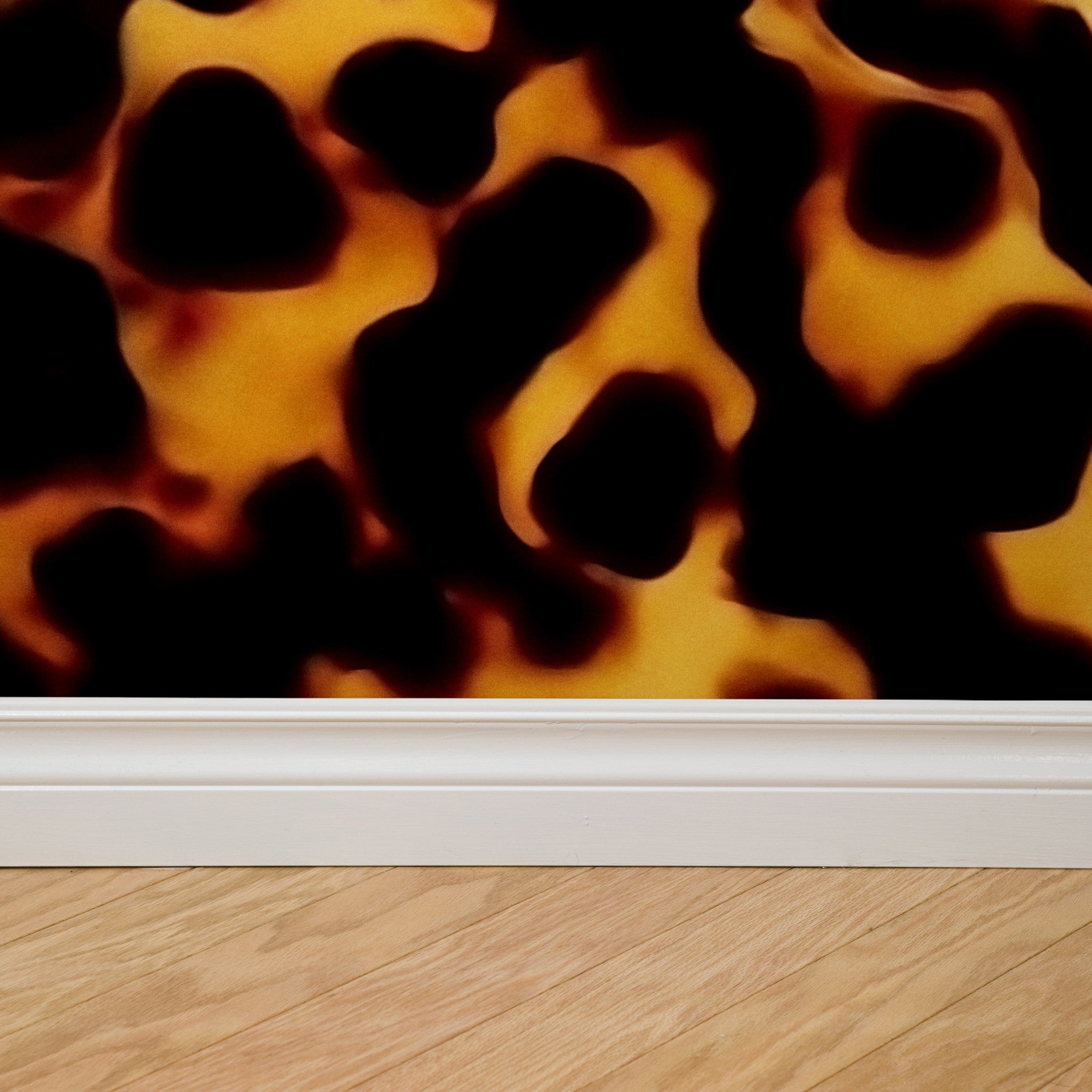 "Hathaway Wallpaper design close-up by Wall Blush on a living room wall, showcasing bold patterns."