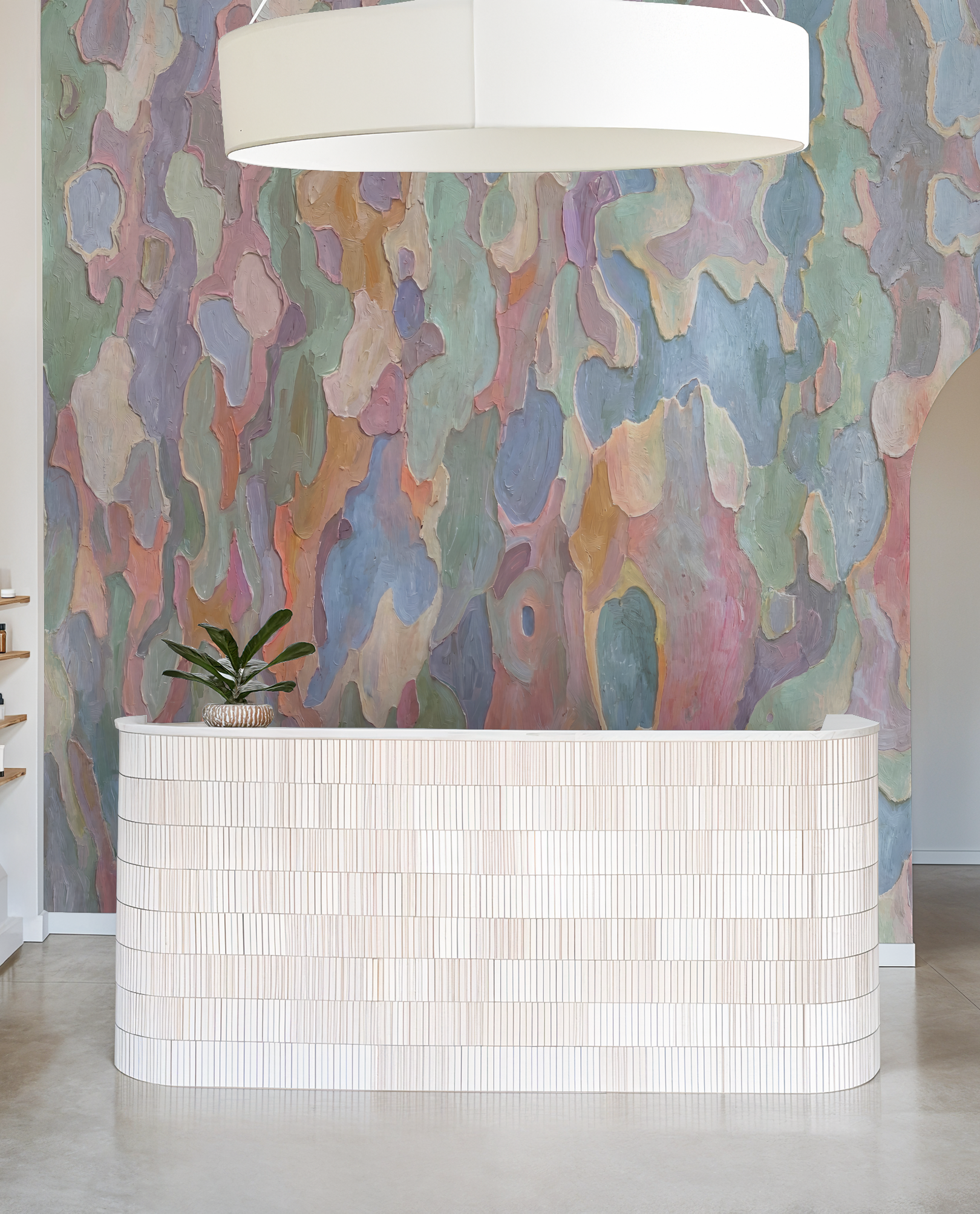 Abstract pastel wallpaper with flowing forms behind a modern reception desk.