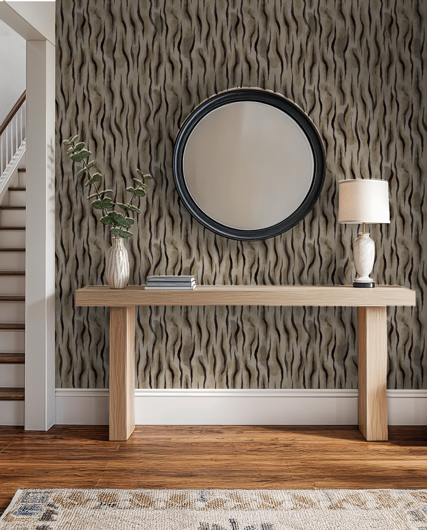 Abstract wavy taupe and charcoal wallpaper in modern entryway with mirror and console table.