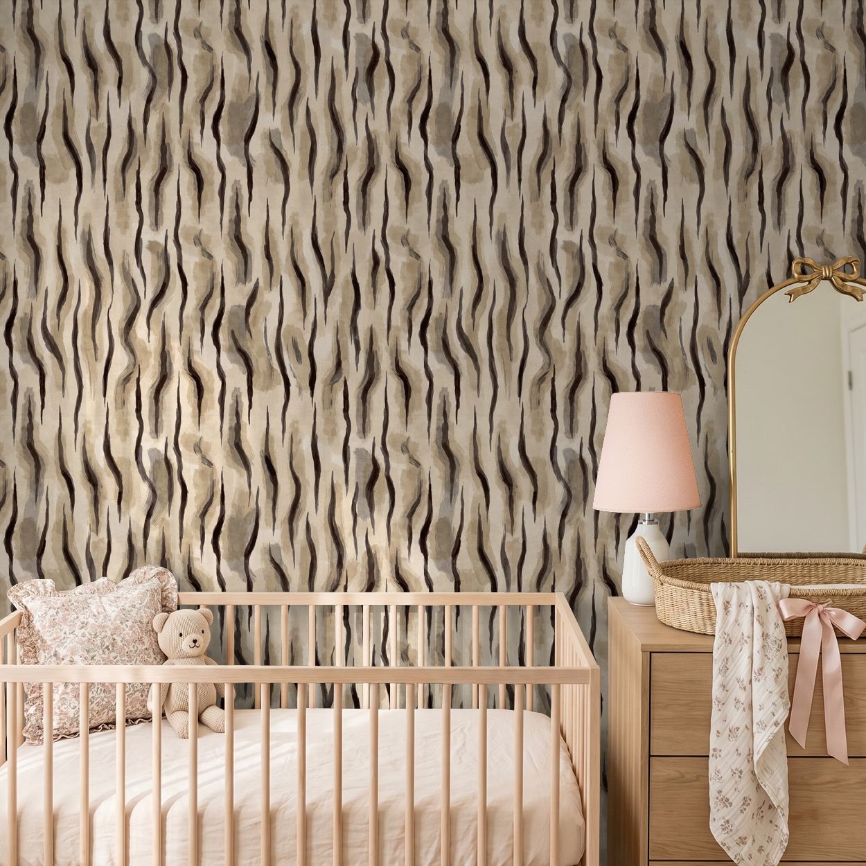 Abstract wavy taupe and charcoal wallpaper in a nursery with crib and dresser.