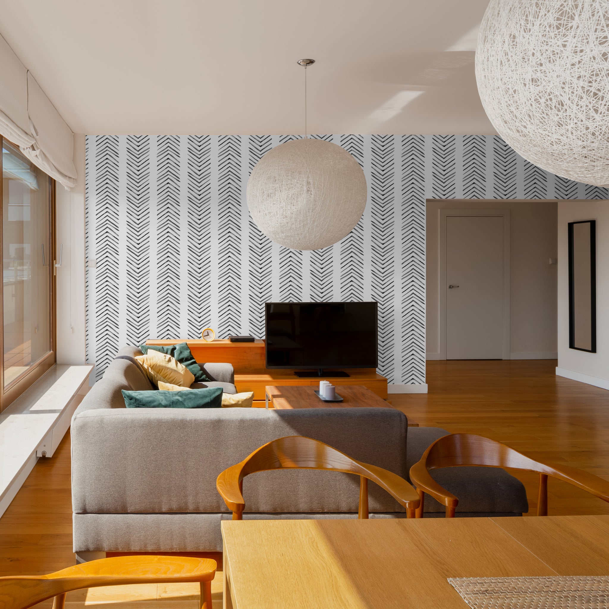 "Modern living room featuring Ar-row Wallpaper by Wall Blush with stylish herringbone pattern accent wall."