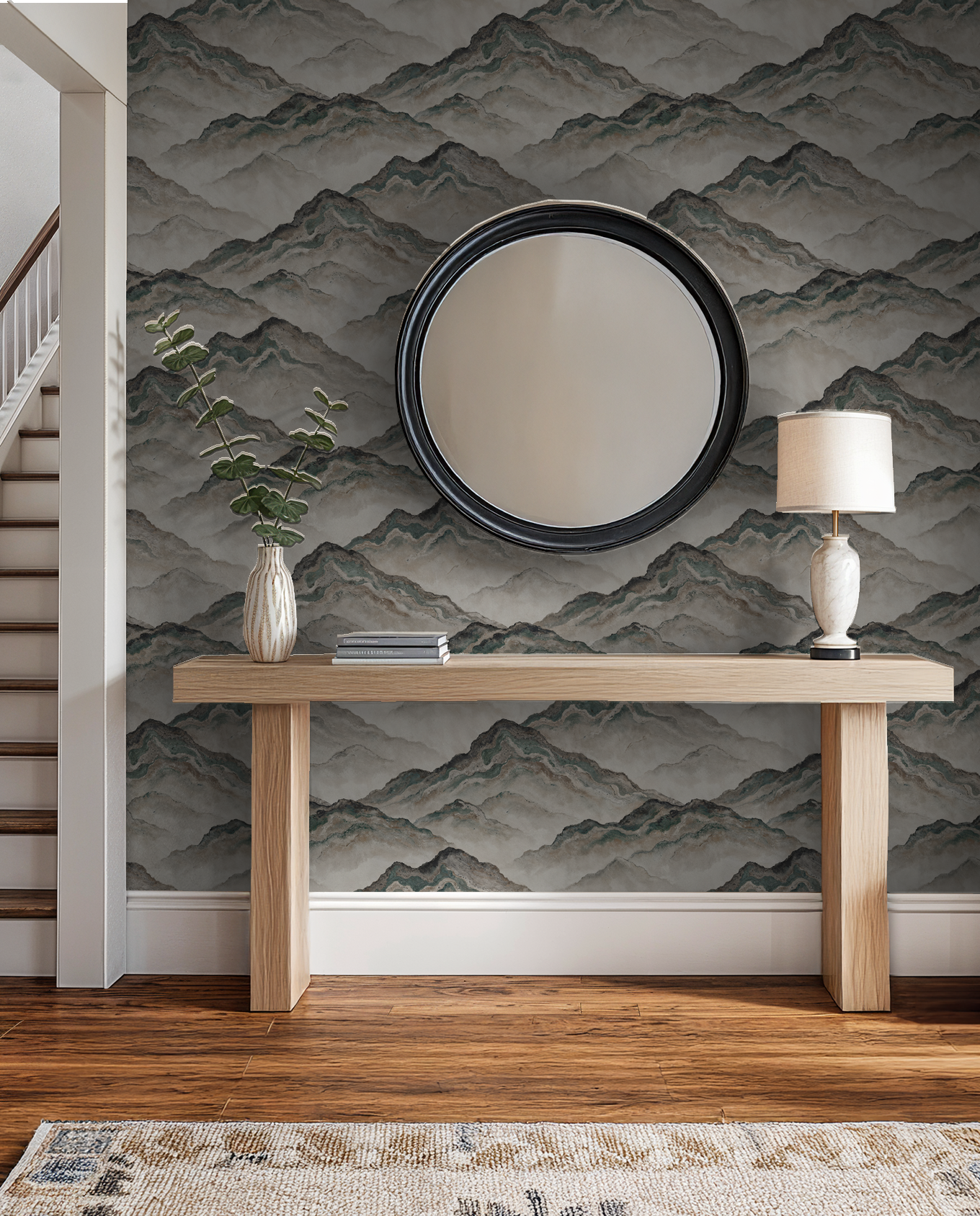 Aurith mountain wallpaper in earthy tones with mirror and wooden console in hallway.
