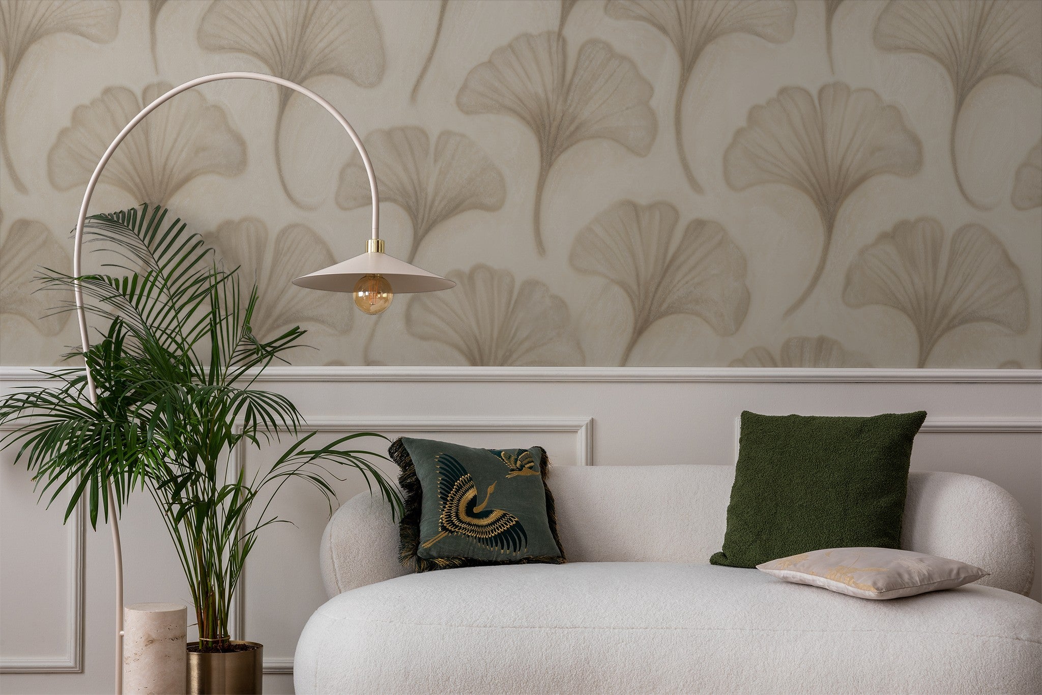 Beige ginkgo leaf wallpaper in elegant living room with white sofa and green accents.