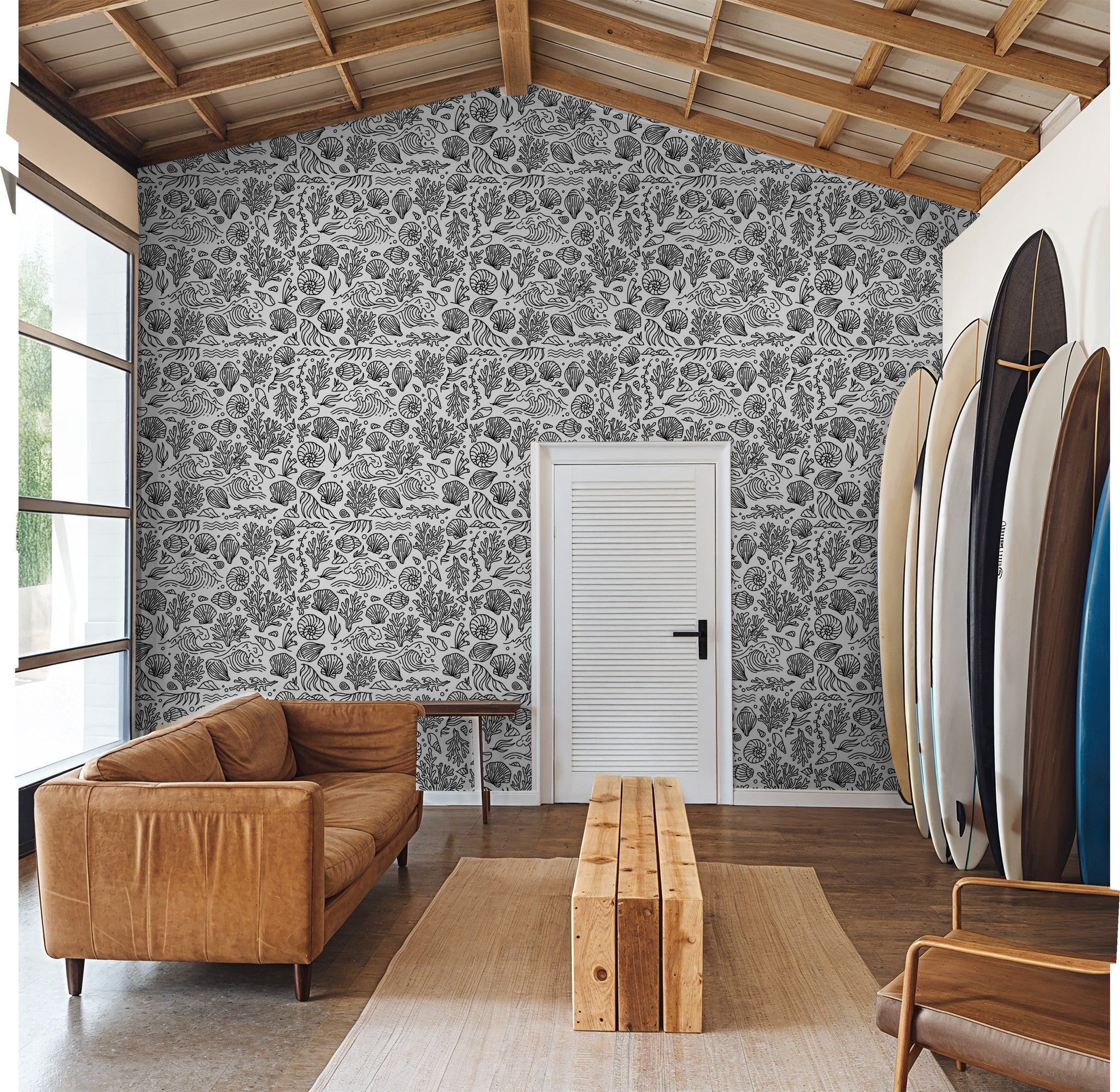Black and white coastal wallpaper with marine motifs in a modern living room.