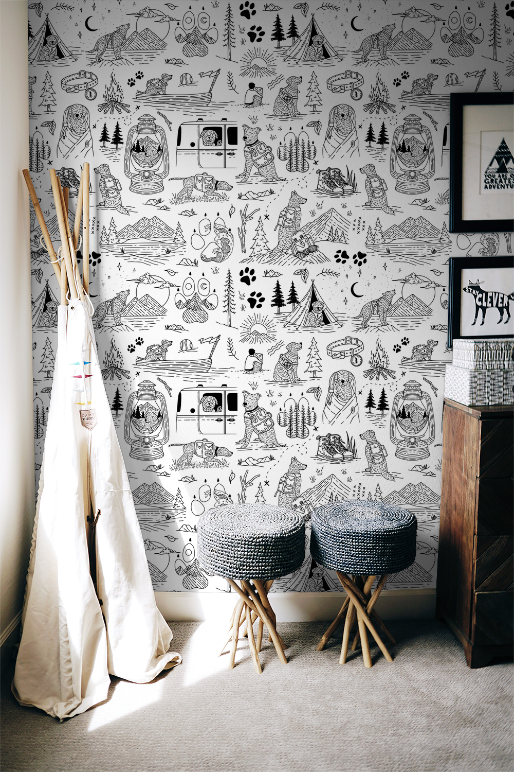 Whimsical black and white dog adventure wallpaper in cozy room with woven stools.