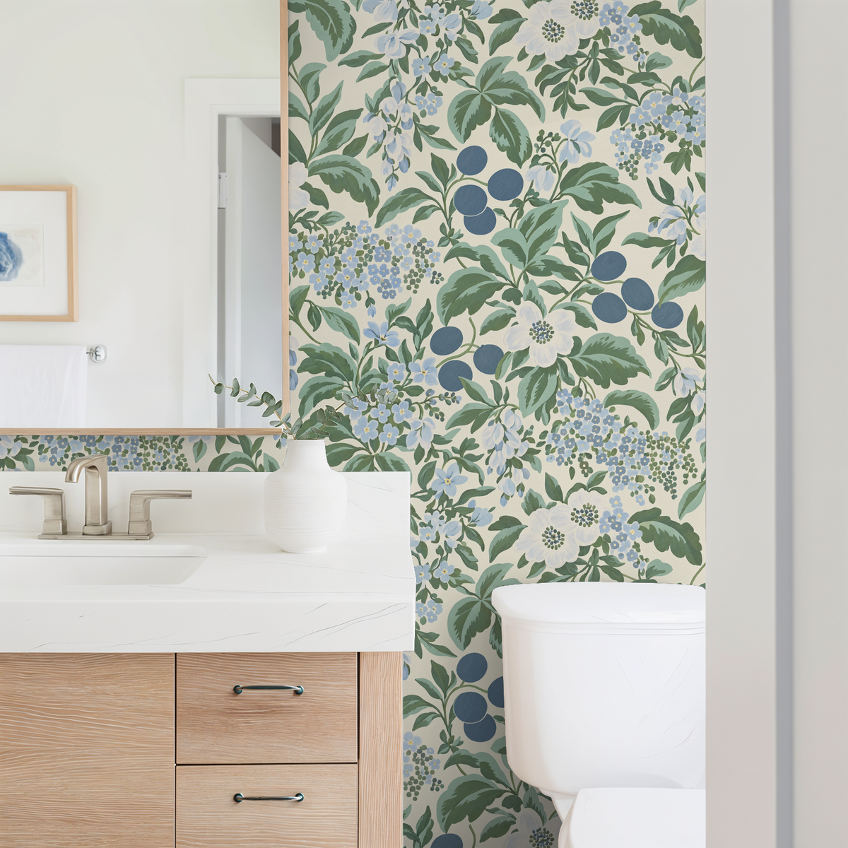 Bloomique Sage and Berry floral wallpaper in bathroom with blue and green botanical pattern.