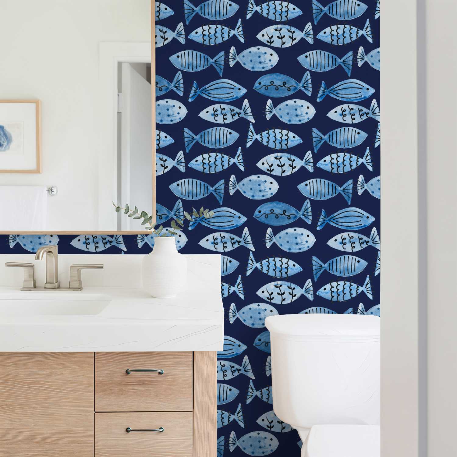 Blue fish pattern wallpaper in bathroom with navy backdrop and white fixtures.