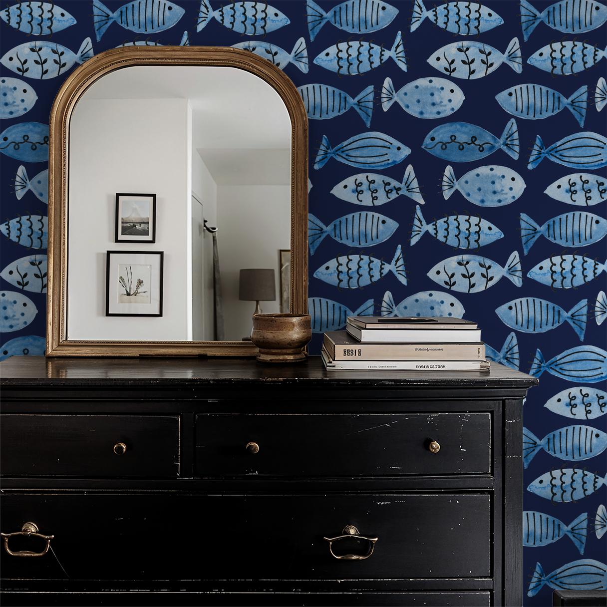 Blue fish patterned wallpaper in nautical-themed room with mirror and dresser.