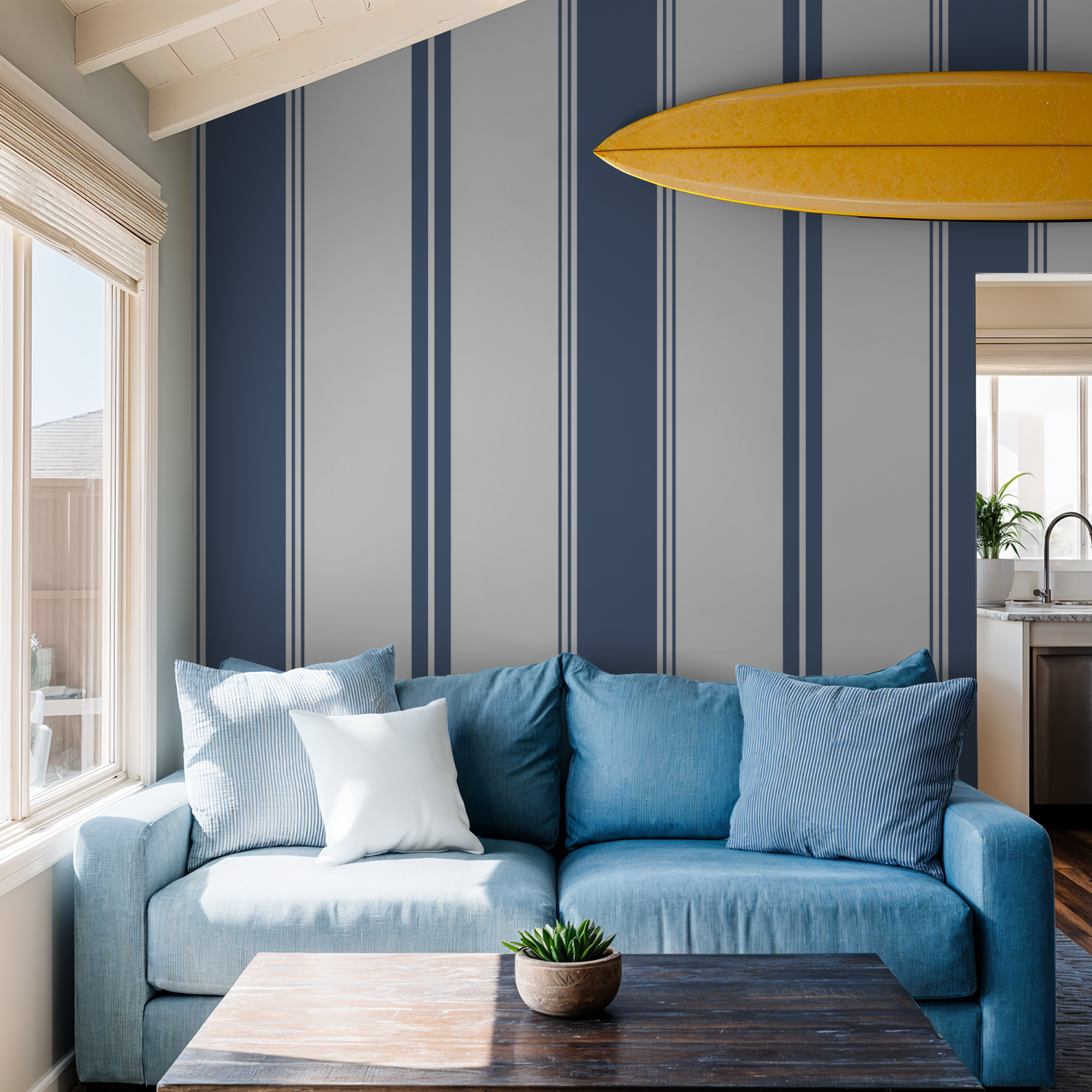 Blue striped wallpaper in modern living room with blue sofa and surfboard decor.