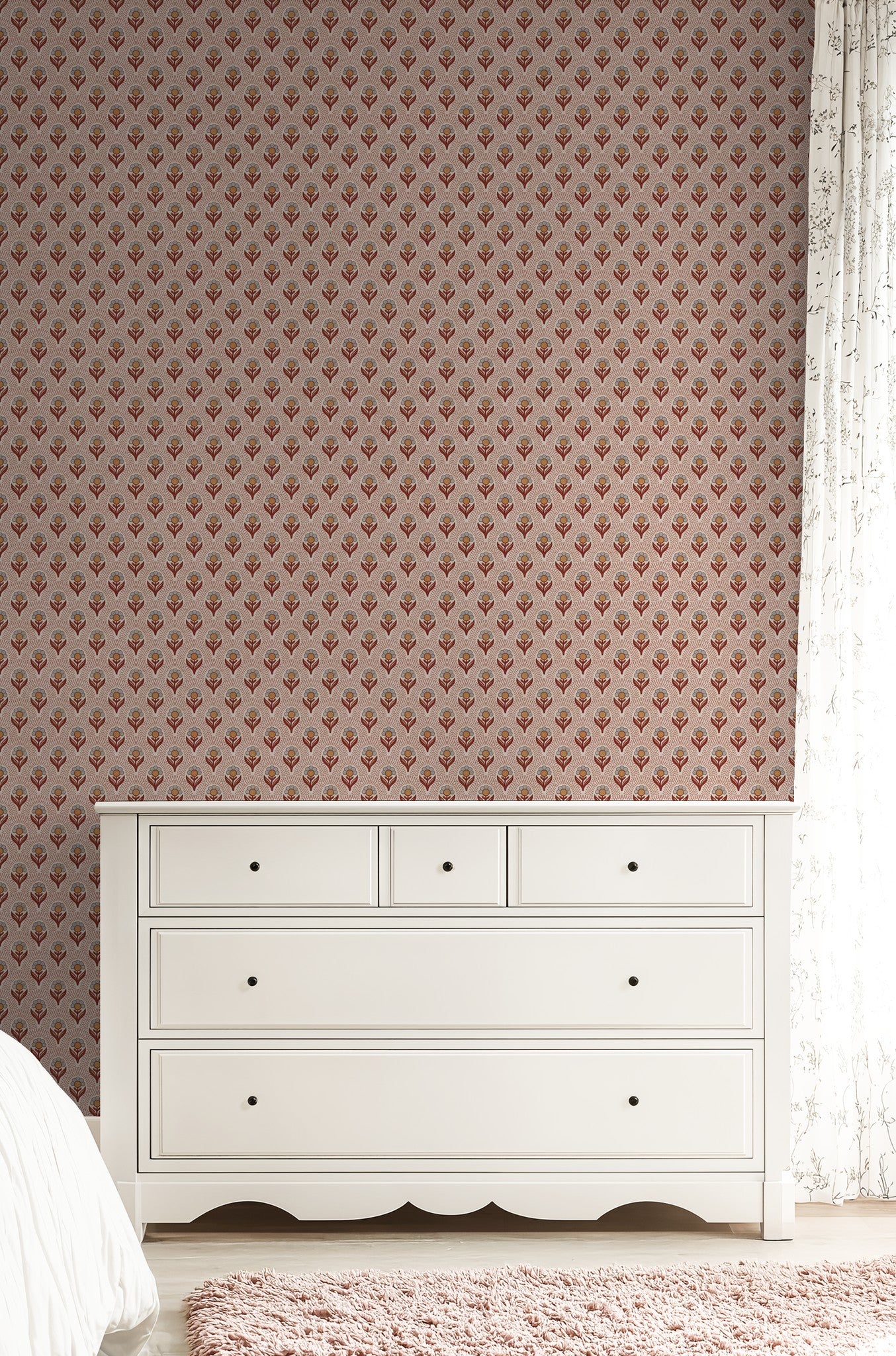 Camellia's Charm wallpaper with rust and ochre florals behind white dresser in bedroom.