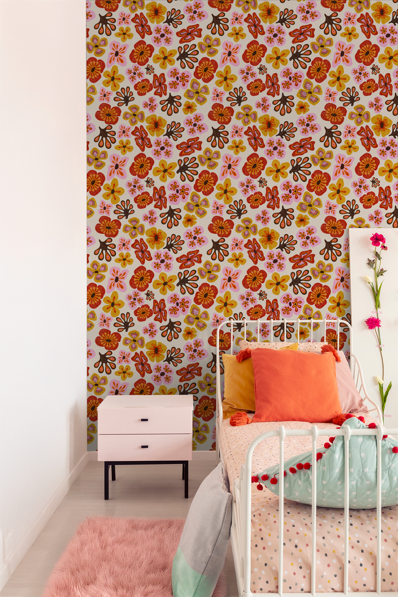Colorful floral wallpaper in a cozy bedroom with vibrant pillows and a pink rug.