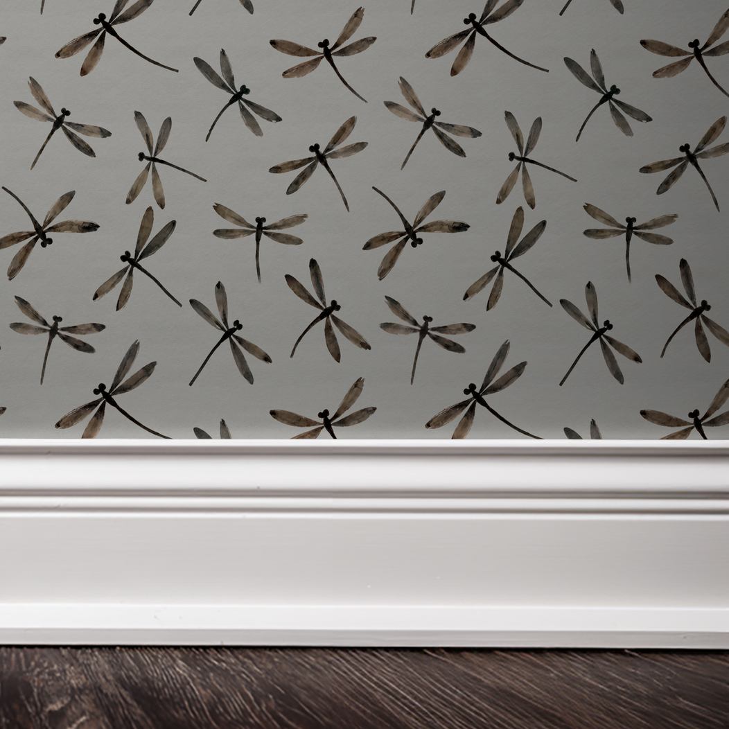 Cream dragonfly pattern wallpaper with muted tones in a room setting.