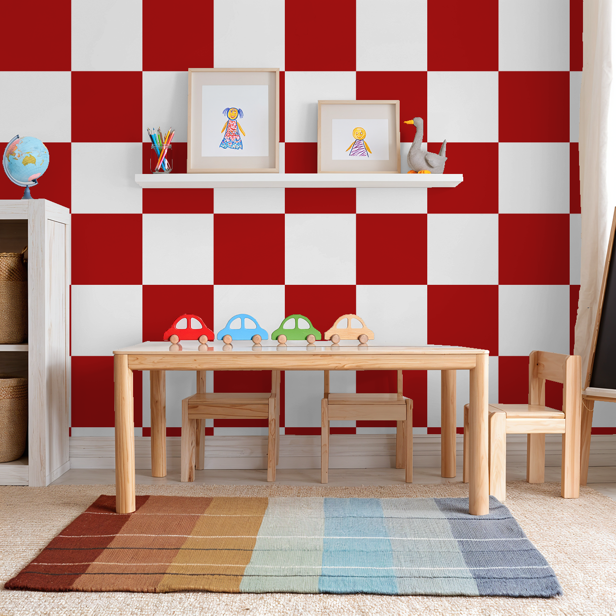 Playroom with large red and white checkerboard wallpaper, wooden table and chairs, colorful rug.