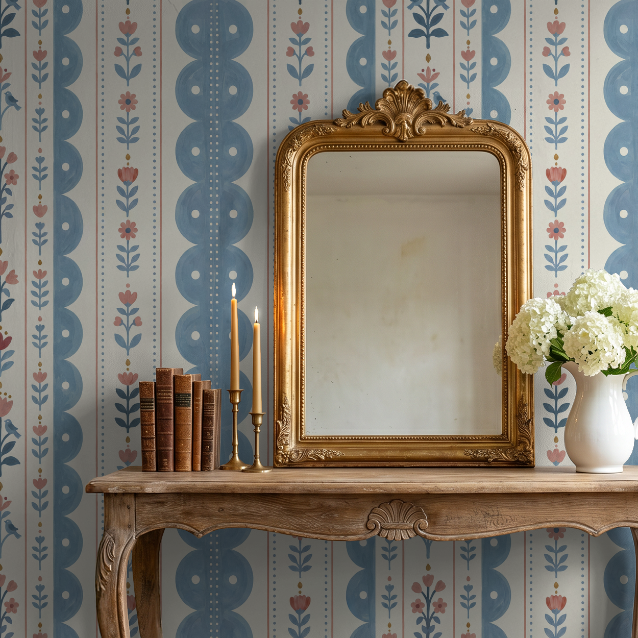 Dahlia Dreams wallpaper with blue and coral floral stripes in vintage room with mirror and table.