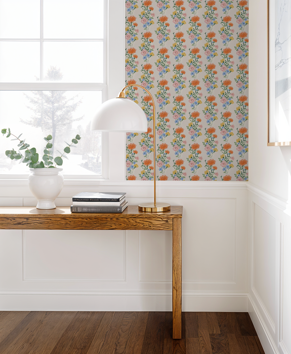 Eden Fields wallpaper with vibrant floral pattern in a bright room with wooden table and lamp.