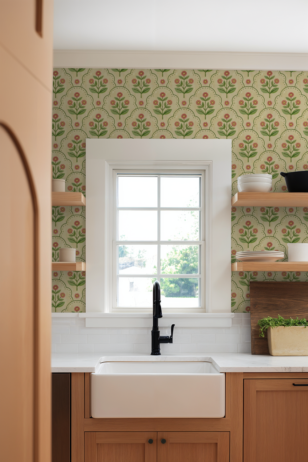 Floral wallpaper with coral and green motifs in a kitchen setting