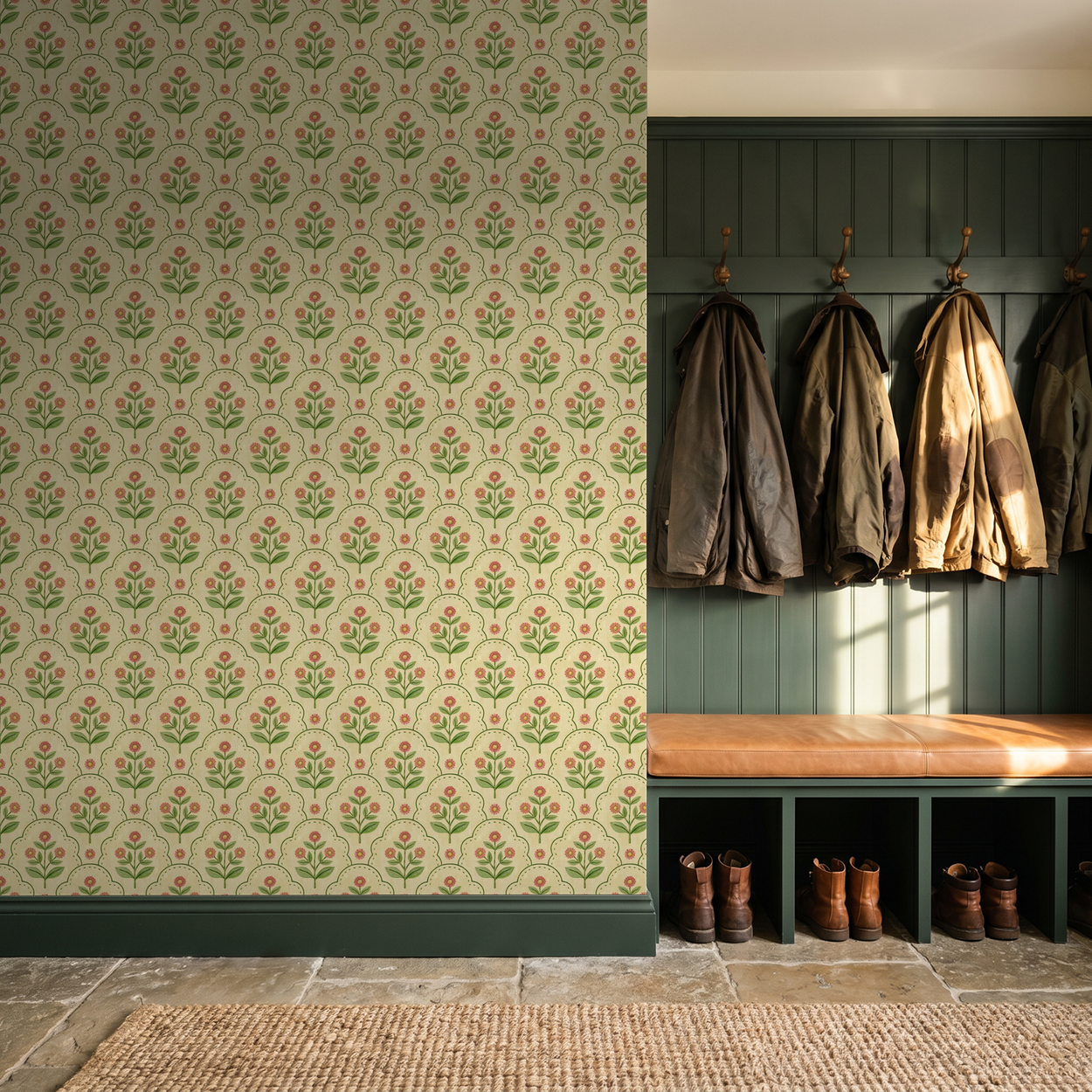 Floral wallpaper with coral and green motifs in a rustic mudroom with coats and boots.