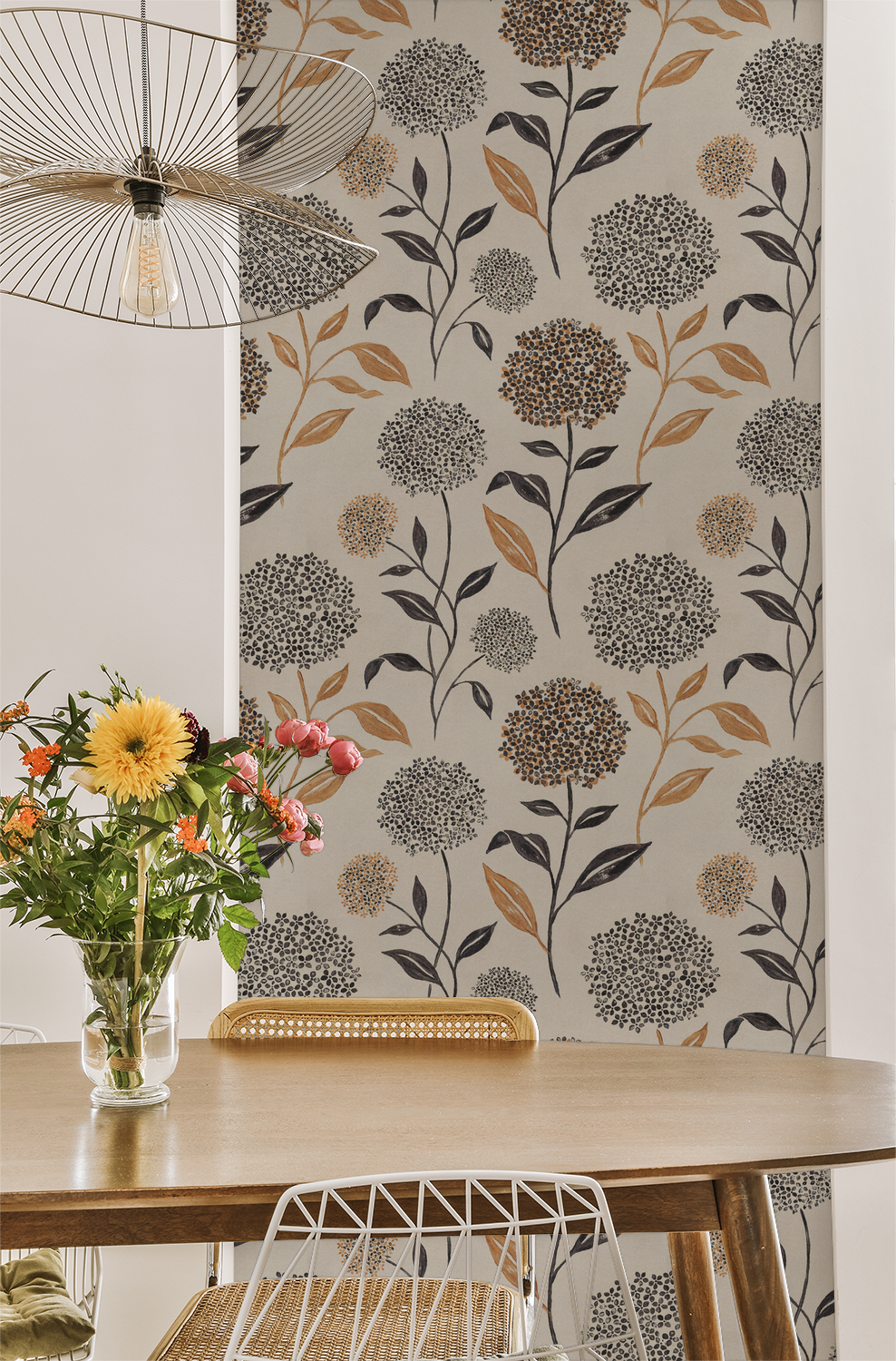 Floral wallpaper with earthy tones and delicate patterns in a dining room setting.
