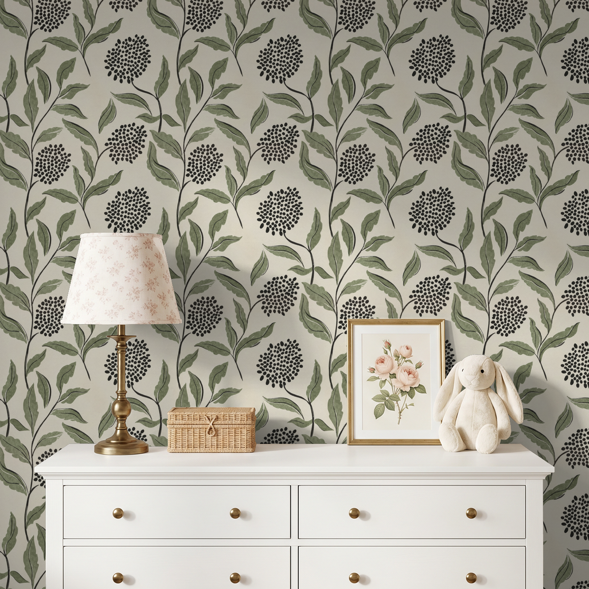 Green botanical wallpaper with sage leaves and charcoal dots in a cozy room setting.