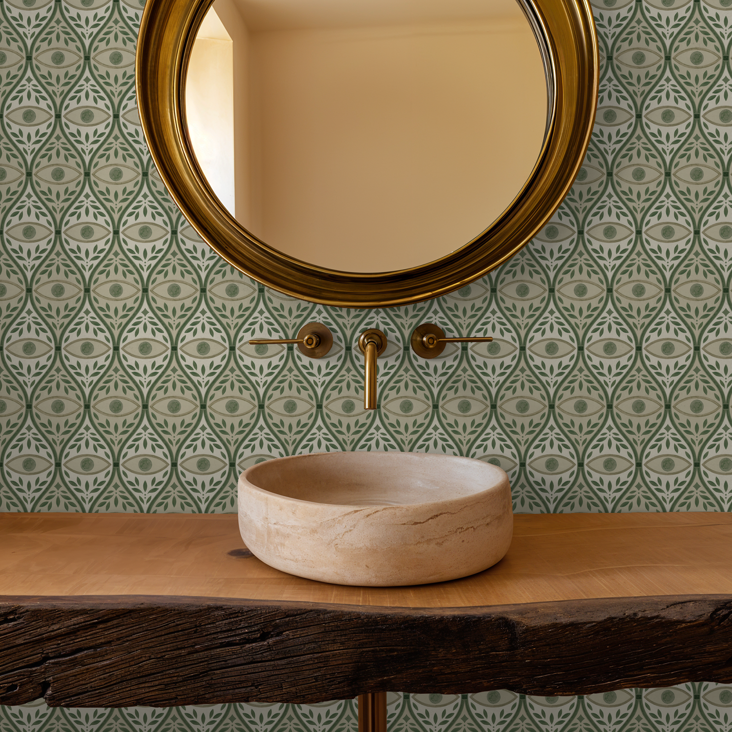 Green geometric leaf pattern wallpaper in bathroom with round mirror and wooden sink