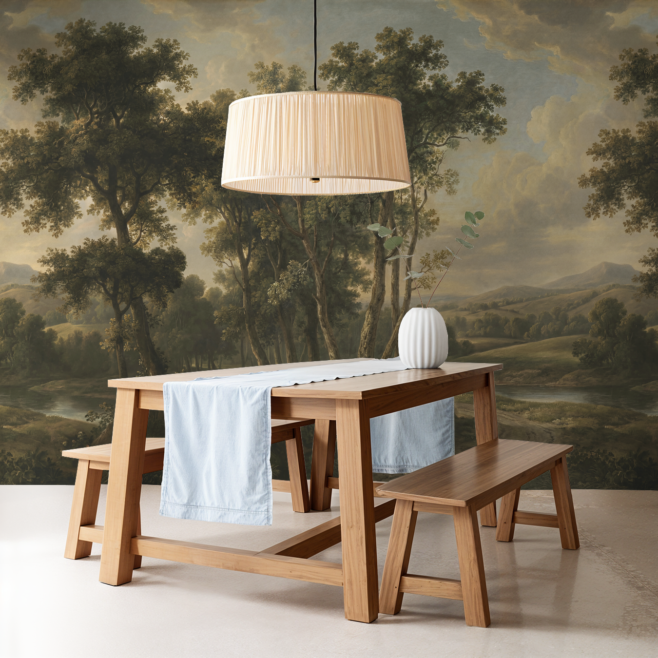 Rustic dining room with landscape wallpaper of trees and hills in earth tones.