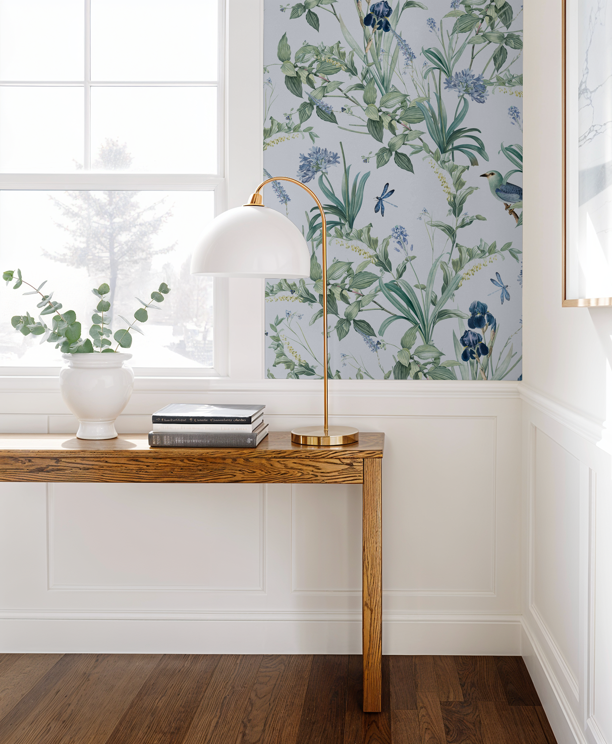 Lavender botanical wallpaper with birds and florals in a bright room with wooden table.