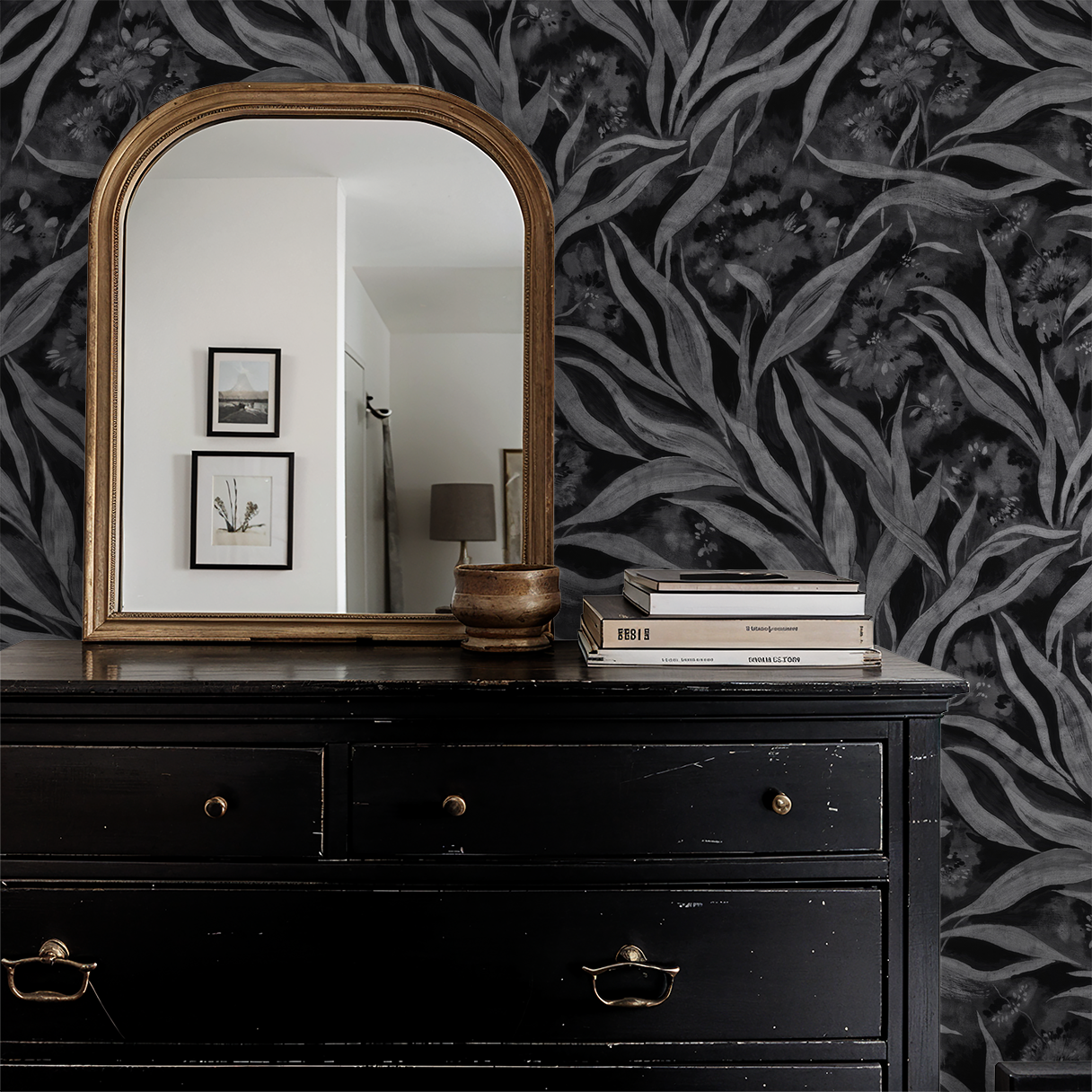 Monochrome foliage wallpaper in elegant dark room with mirror and dresser