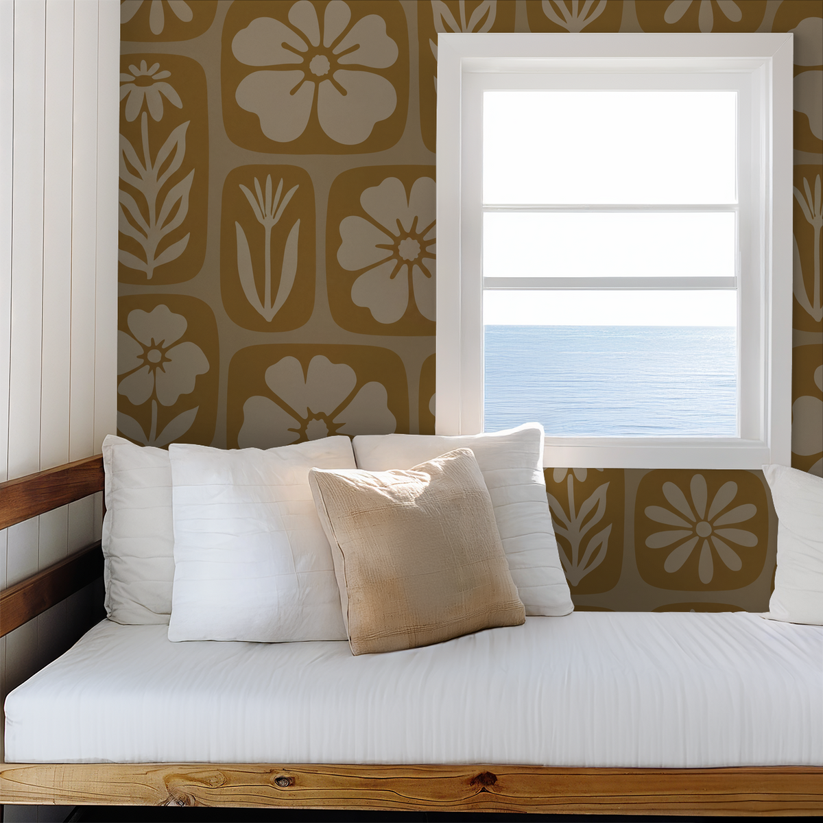 Mustard floral wallpaper with geometric frames in a cozy room with ocean view.
