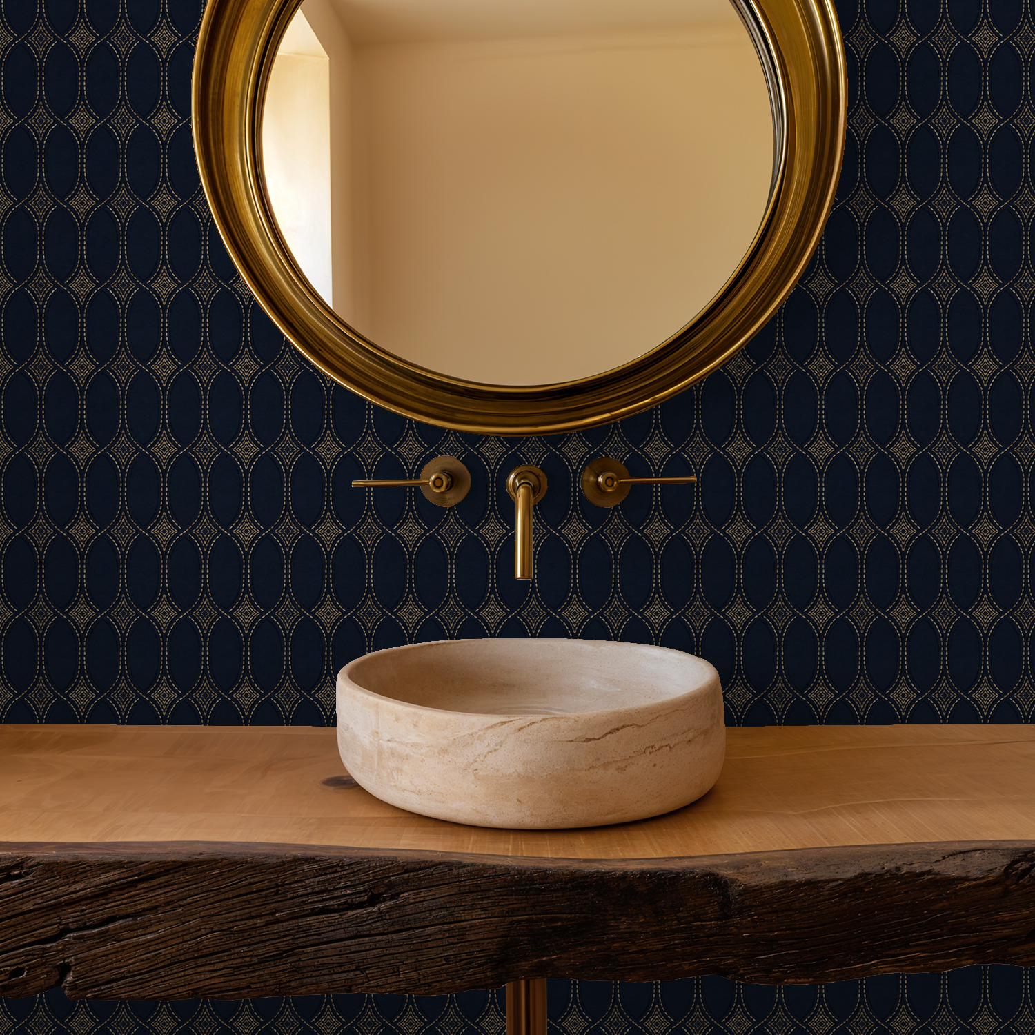 Elegant navy and gold geometric wallpaper in bathroom with round mirror and stone sink.