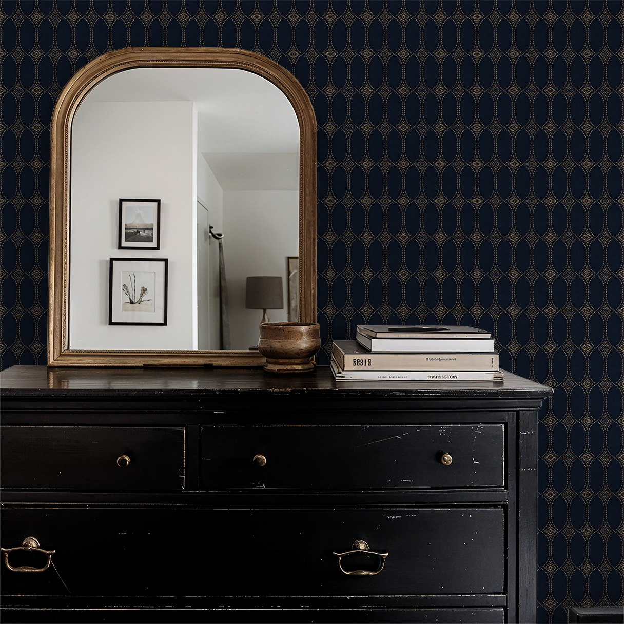 Navy and gold geometric wallpaper in elegant room with mirror and dresser.
