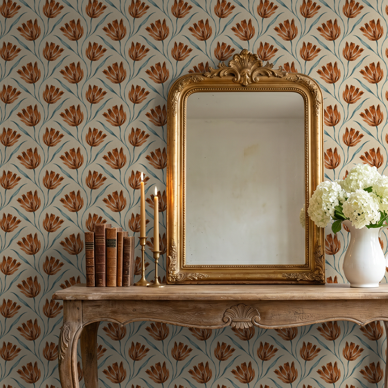 Terracotta floral wallpaper with gold mirror and wooden table decor.