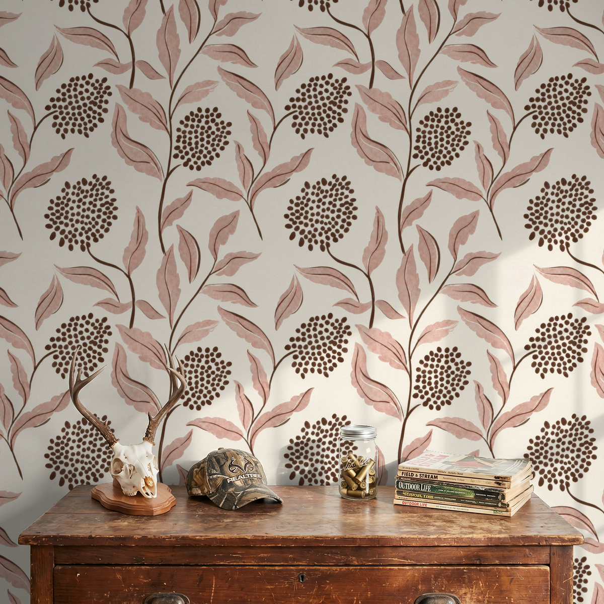 Pink botanical wallpaper with leaves and berries in a cozy room setting.