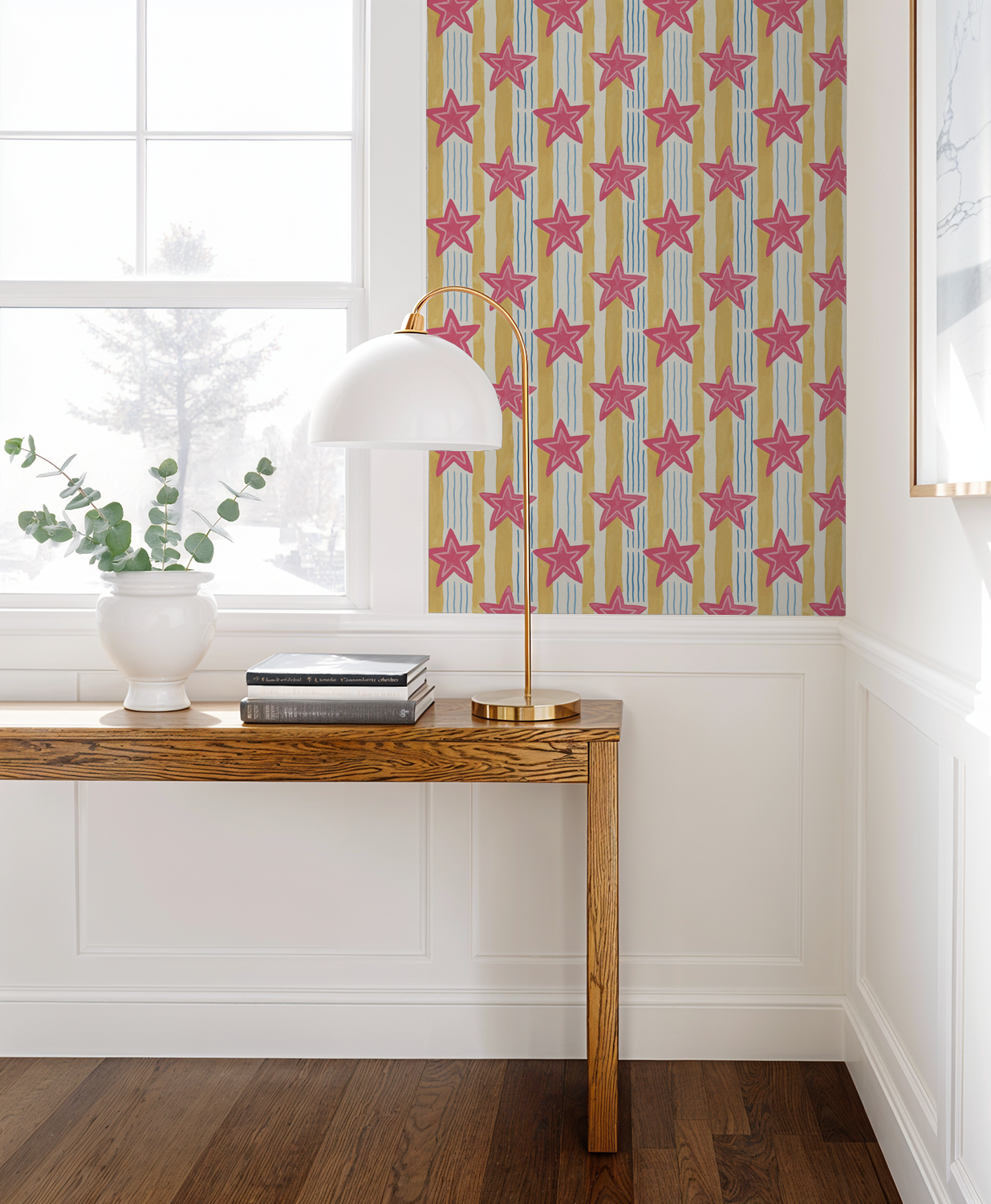Pink star wallpaper with yellow and blue stripes in a bright room with wooden table.