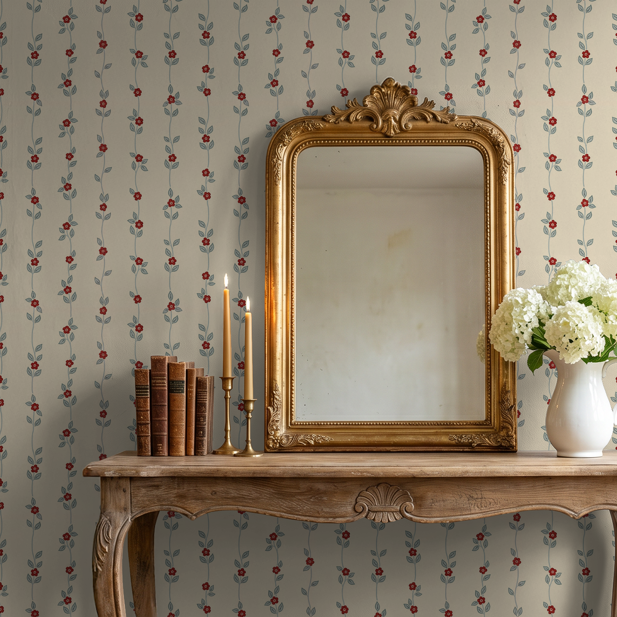Vintage wallpaper with red floral vines on cream in elegant room with mirror and flowers.