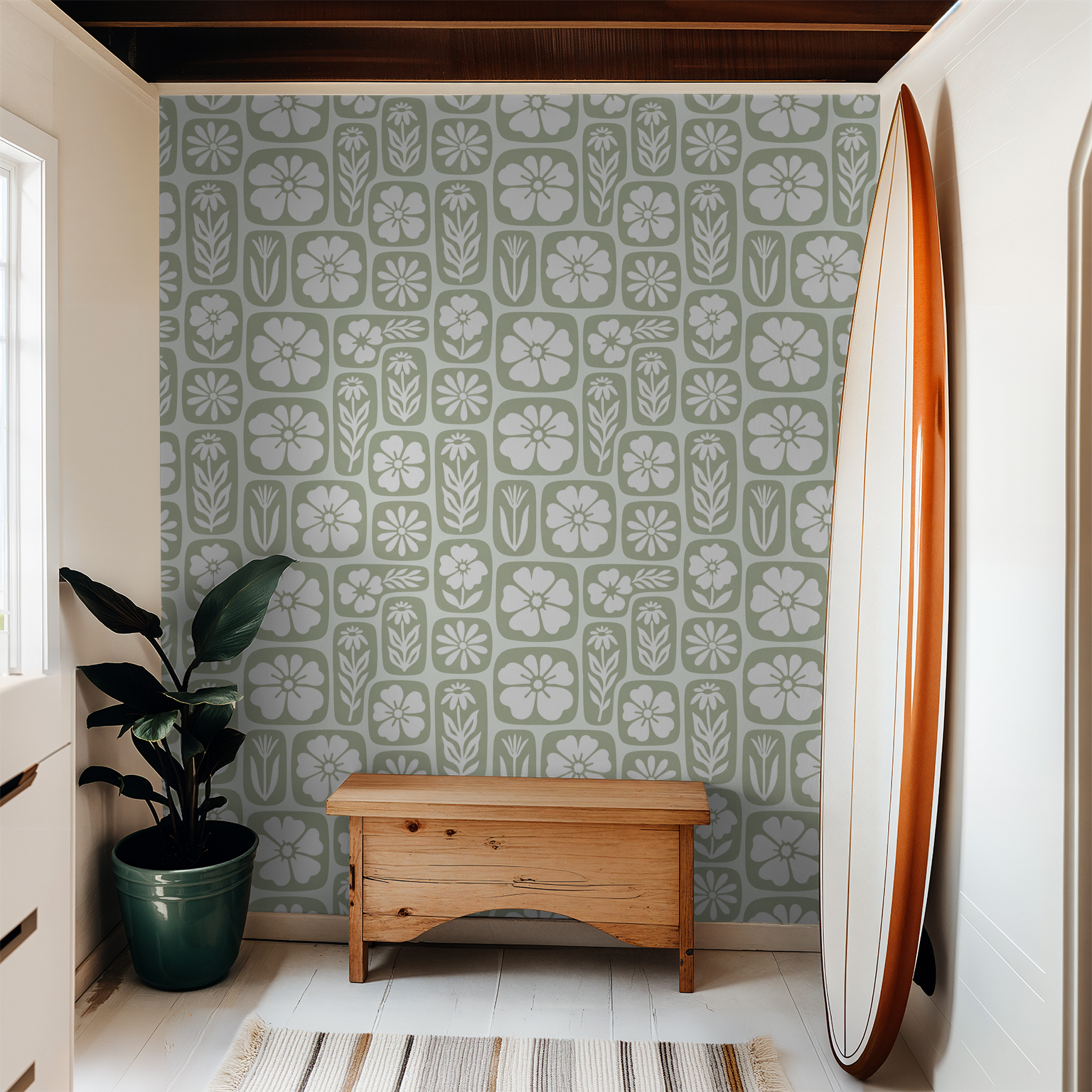 Sage green floral wallpaper with white motifs in a cozy room with wooden bench and surfboard.
