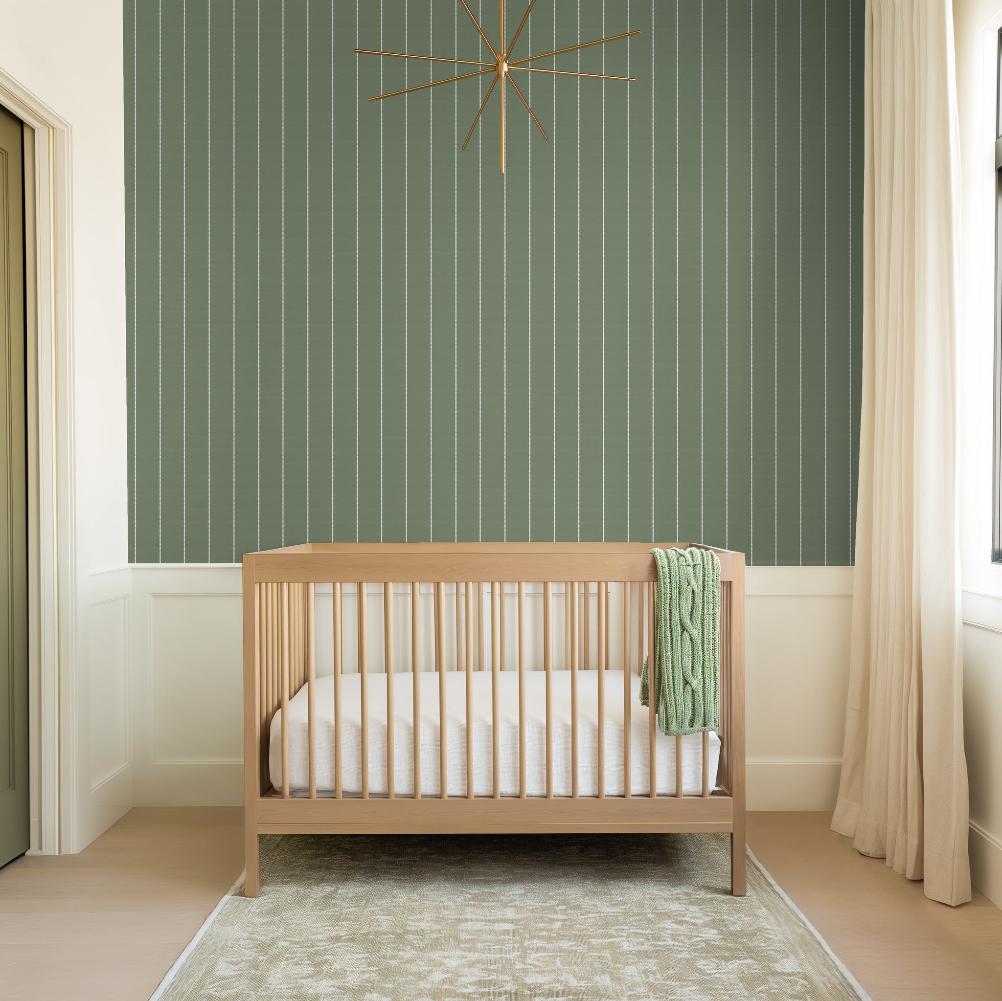 Sage green pinstripe dot wallpaper in a modern nursery with wooden crib.