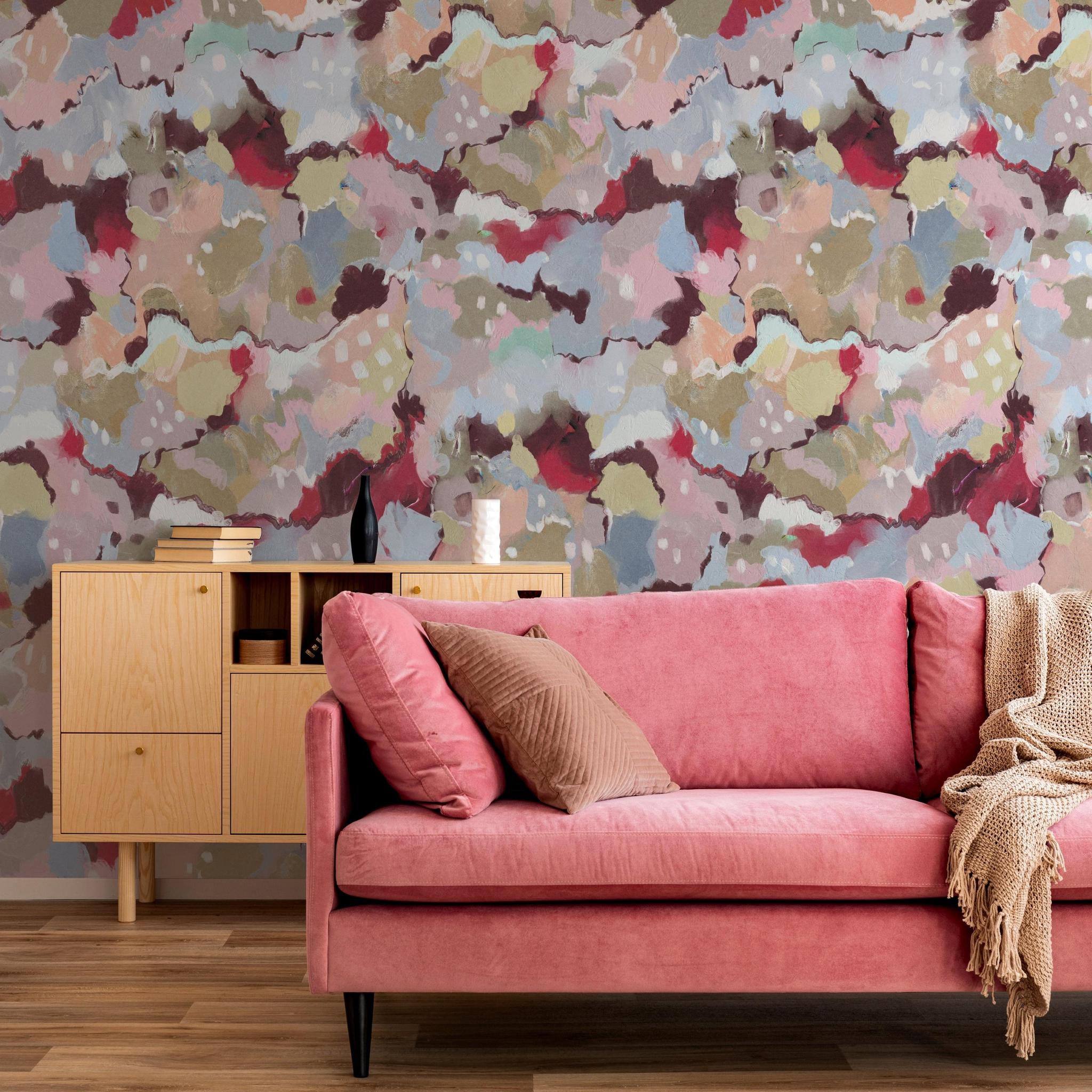 Wall Blush SG02 Petunia Wallpaper featuring in modern living room with pink sofa and wooden furniture.