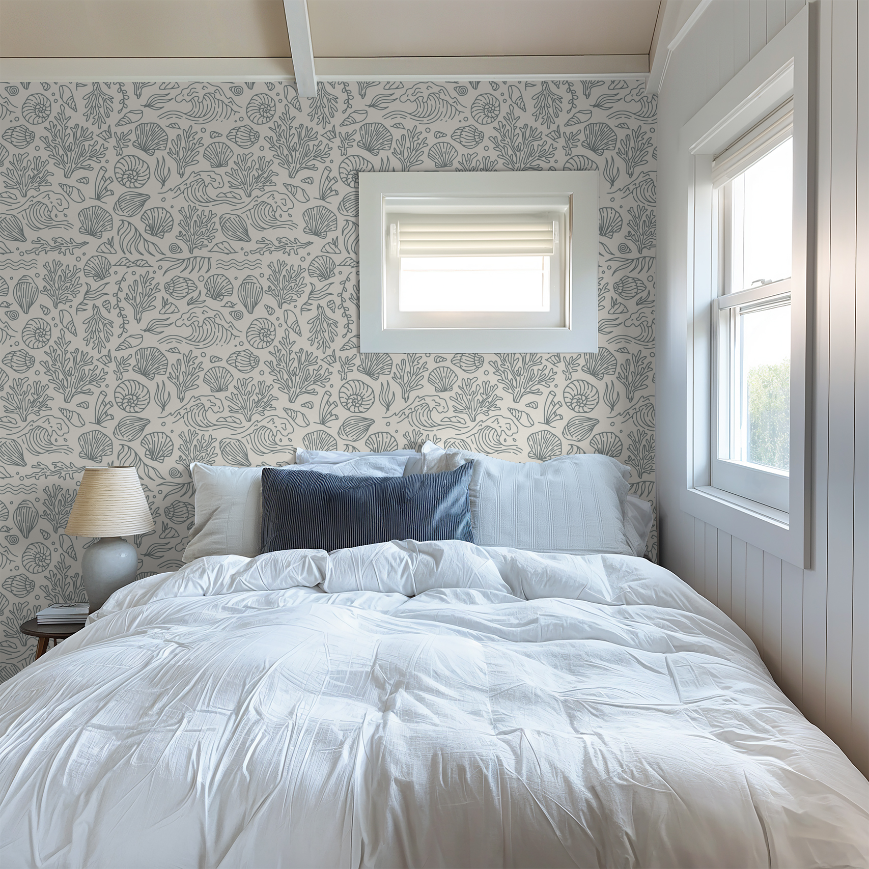 Coastal marine life wallpaper in dusty blue and cream in serene bedroom setting.