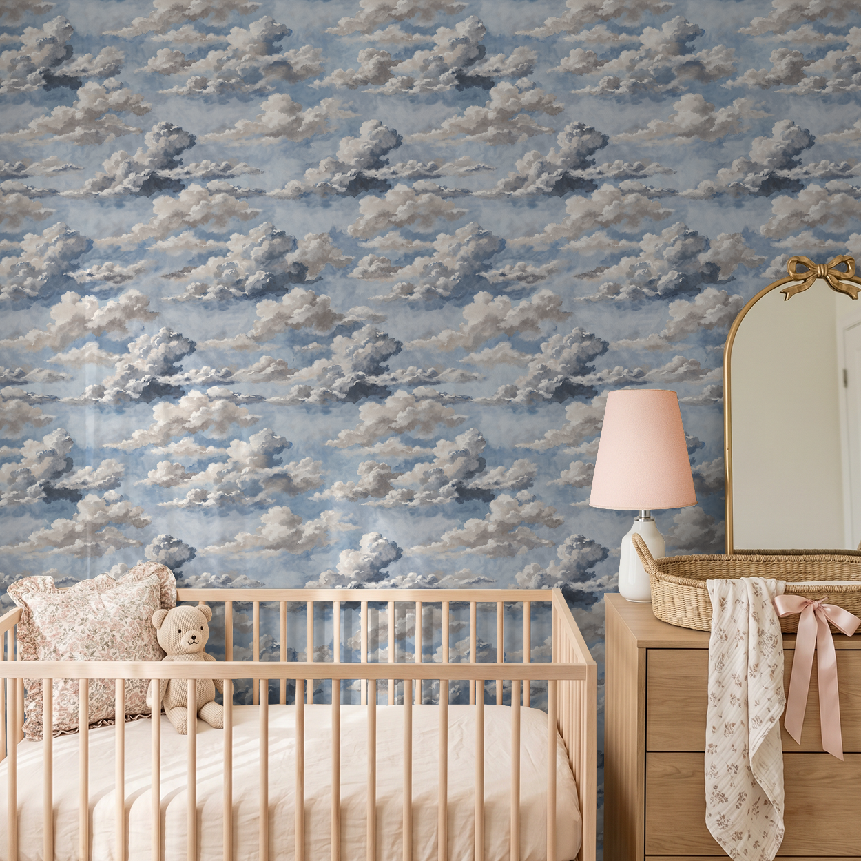 Skyphoria cloud wallpaper in nursery with crib and dresser, soft blue and gray tones.