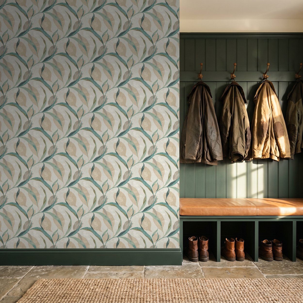 Teal and beige leaf pattern wallpaper in a rustic mudroom with coats and boots.