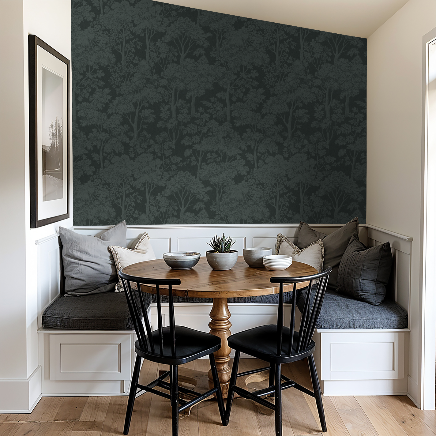 Teal tree canopy wallpaper in cozy dining nook with wooden table and chairs.