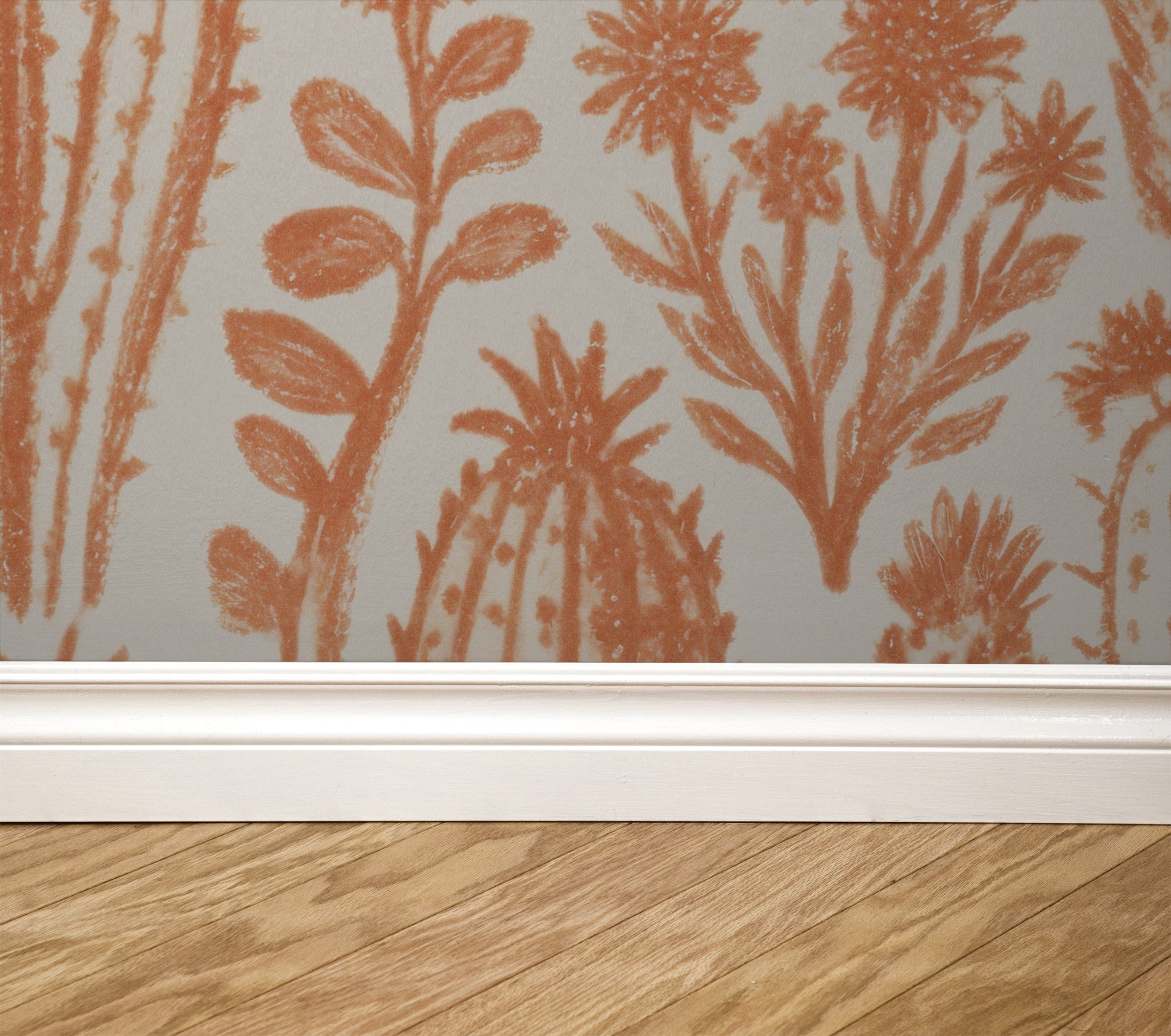 Terracotta cactus and floral pattern wallpaper with white baseboard and wood floor.
