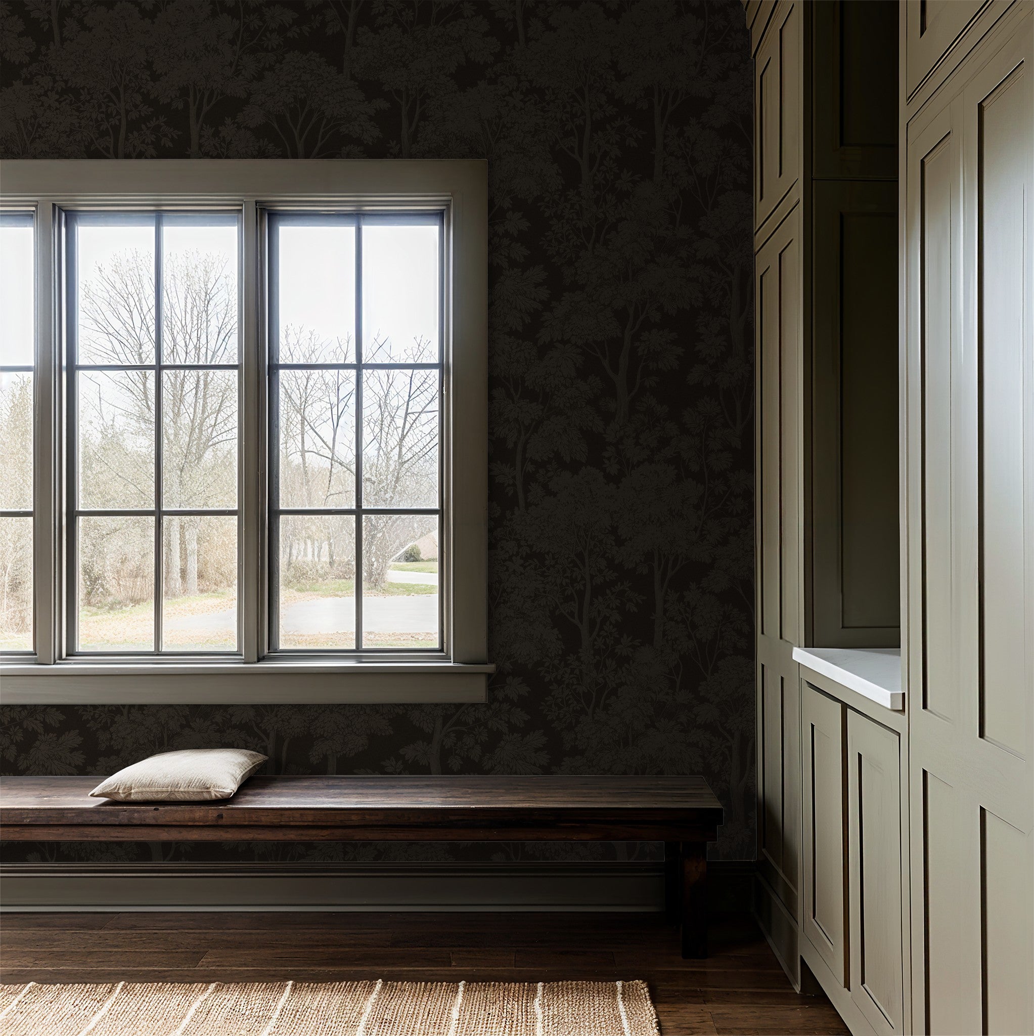 Twilight Canopy bronze wallpaper with tree silhouettes in cozy room with window bench.