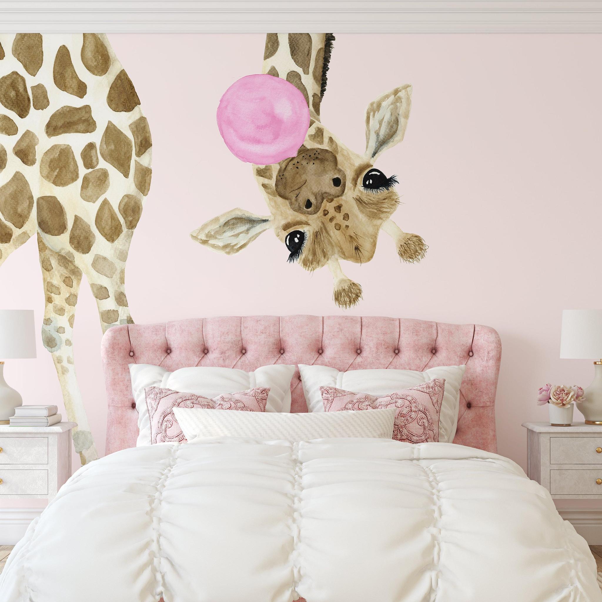 Wall Blush's Stevie Kate Wallpaper in a stylish bedroom, featuring whimsical giraffe designs with a pink backdrop.