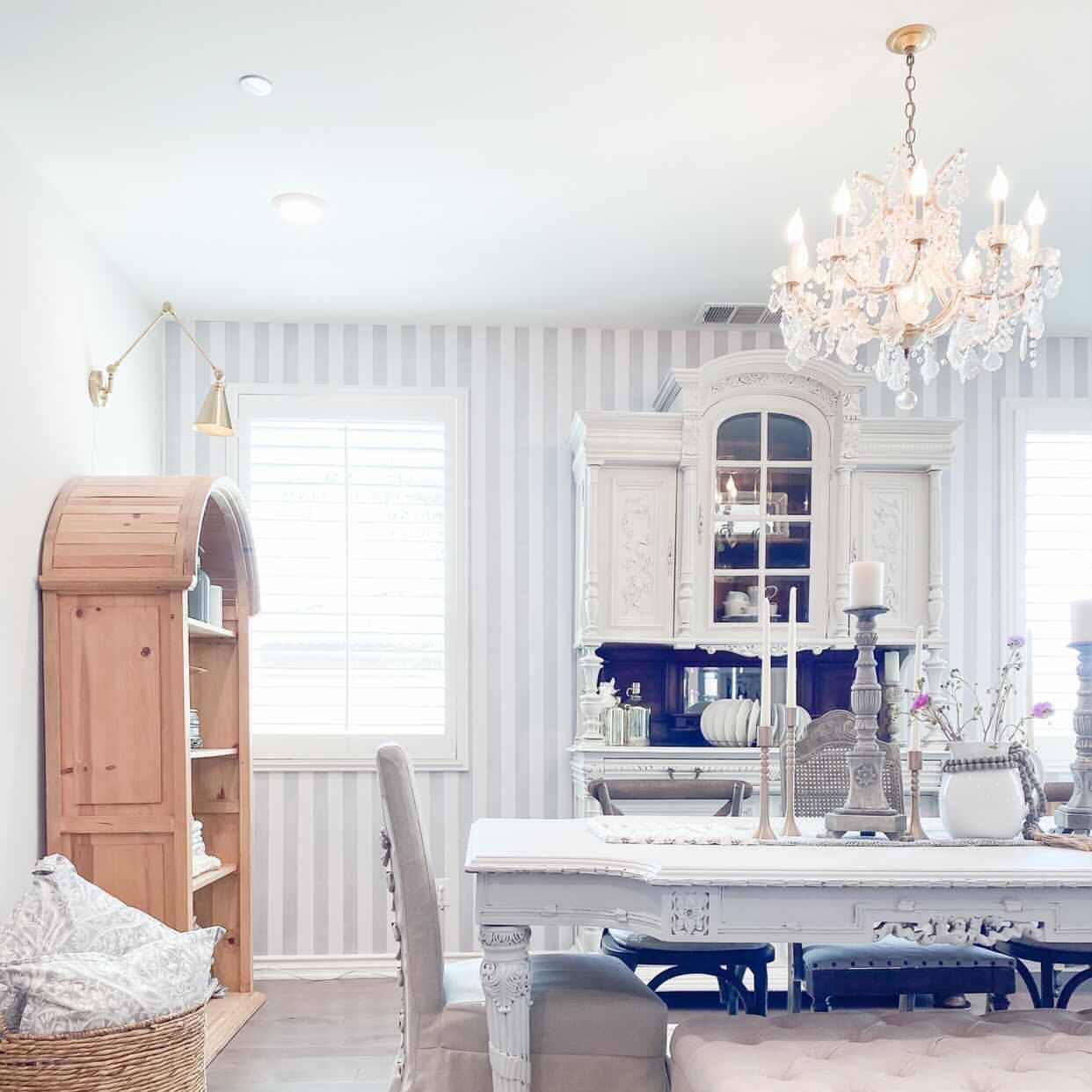 Elegant dining room featuring Gabbandra Stripes Wallpaper from The 7th Haven Interiors Line, accentuating a refined decor.