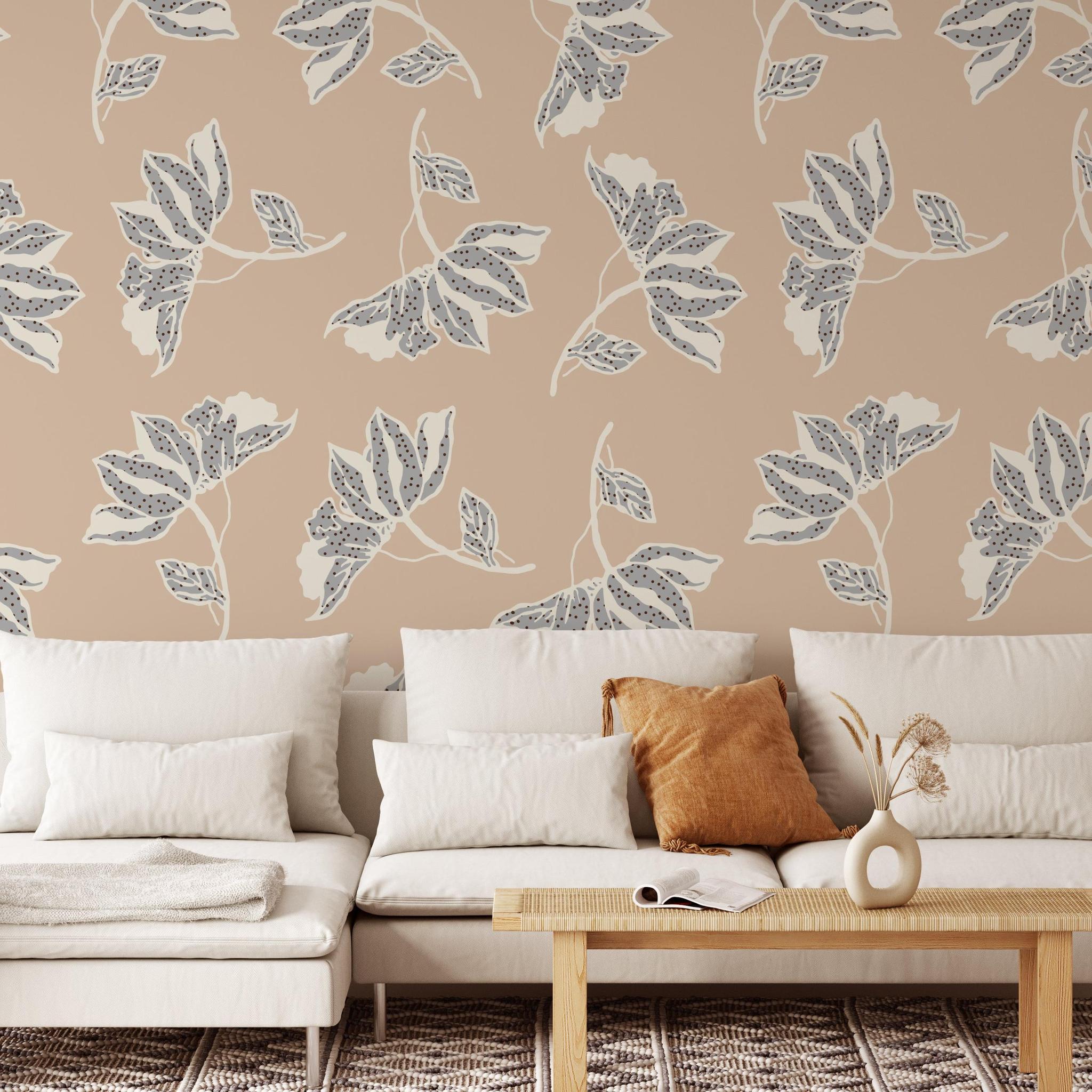 Wall Blush Leah Wallpaper in a cozy living room, showcasing leafy designs and neutral tones.