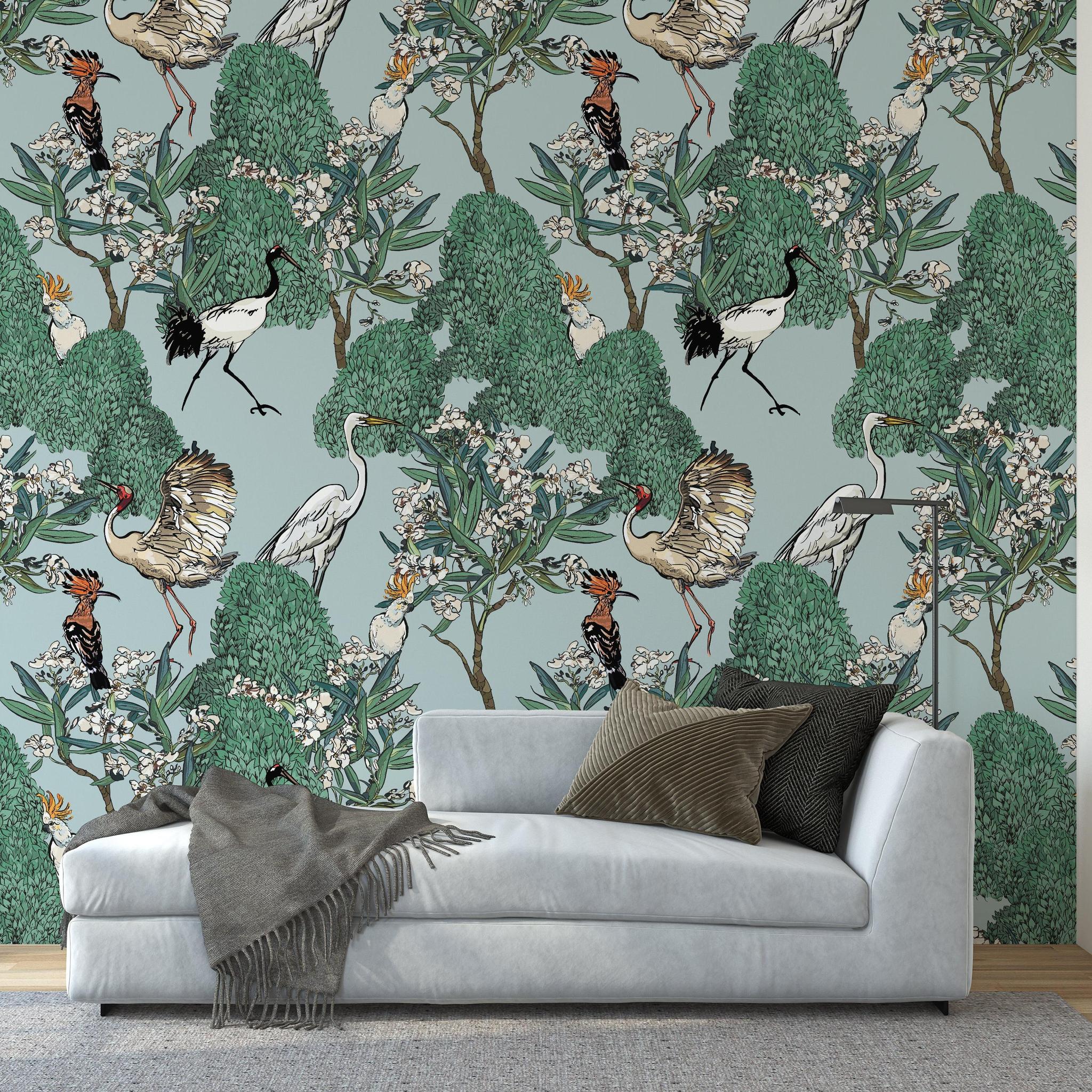 Wall Blush Mangrove Wallpaper in a stylish living room with modern couch and bookshelf.